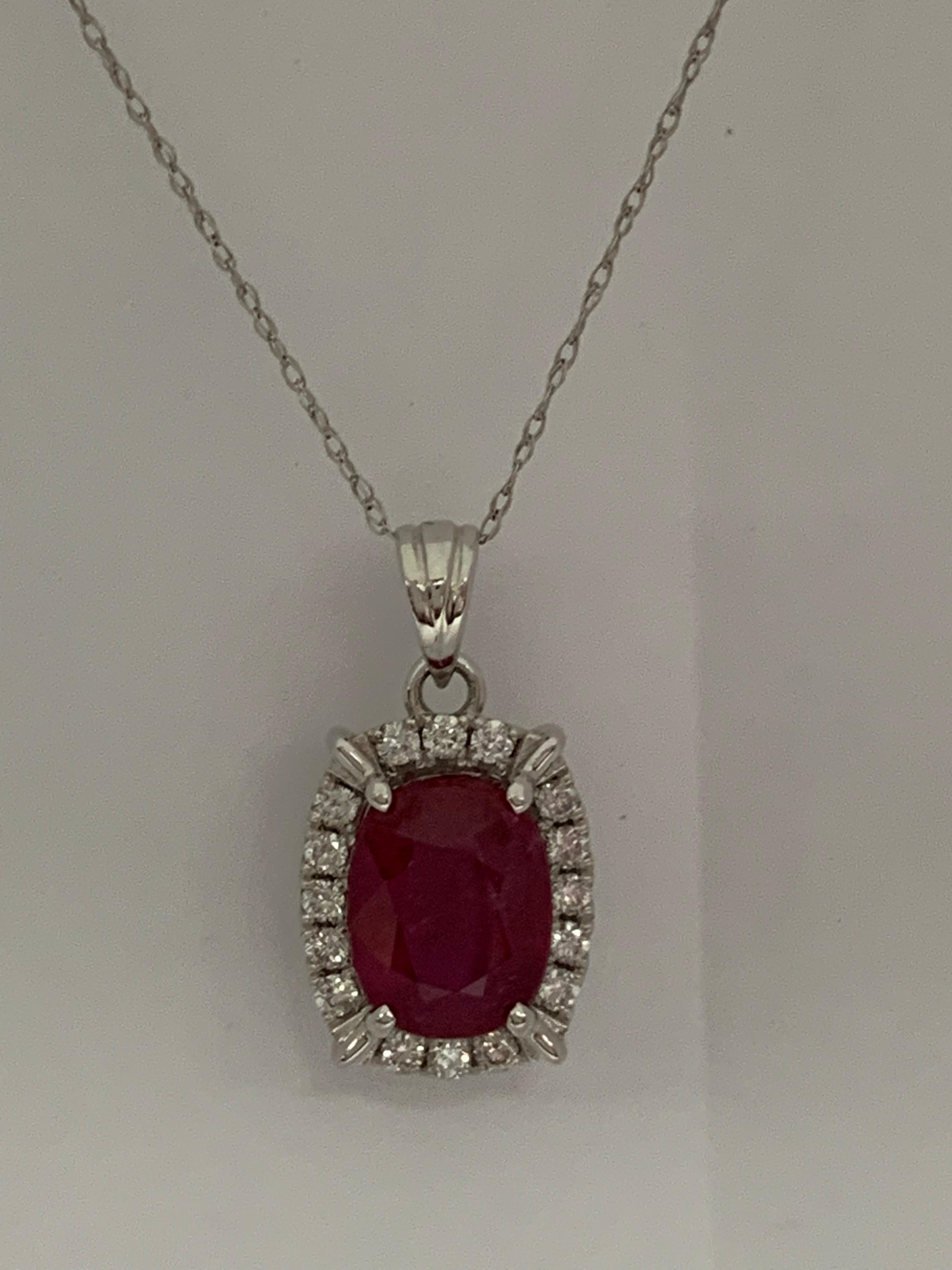 Natural Ruby set in 14 Karat white gold with 0.27 Carat white diamonds.The Pendant includes 14 Karat 18 inches chain.The pendant is one of a kind handcrafted.