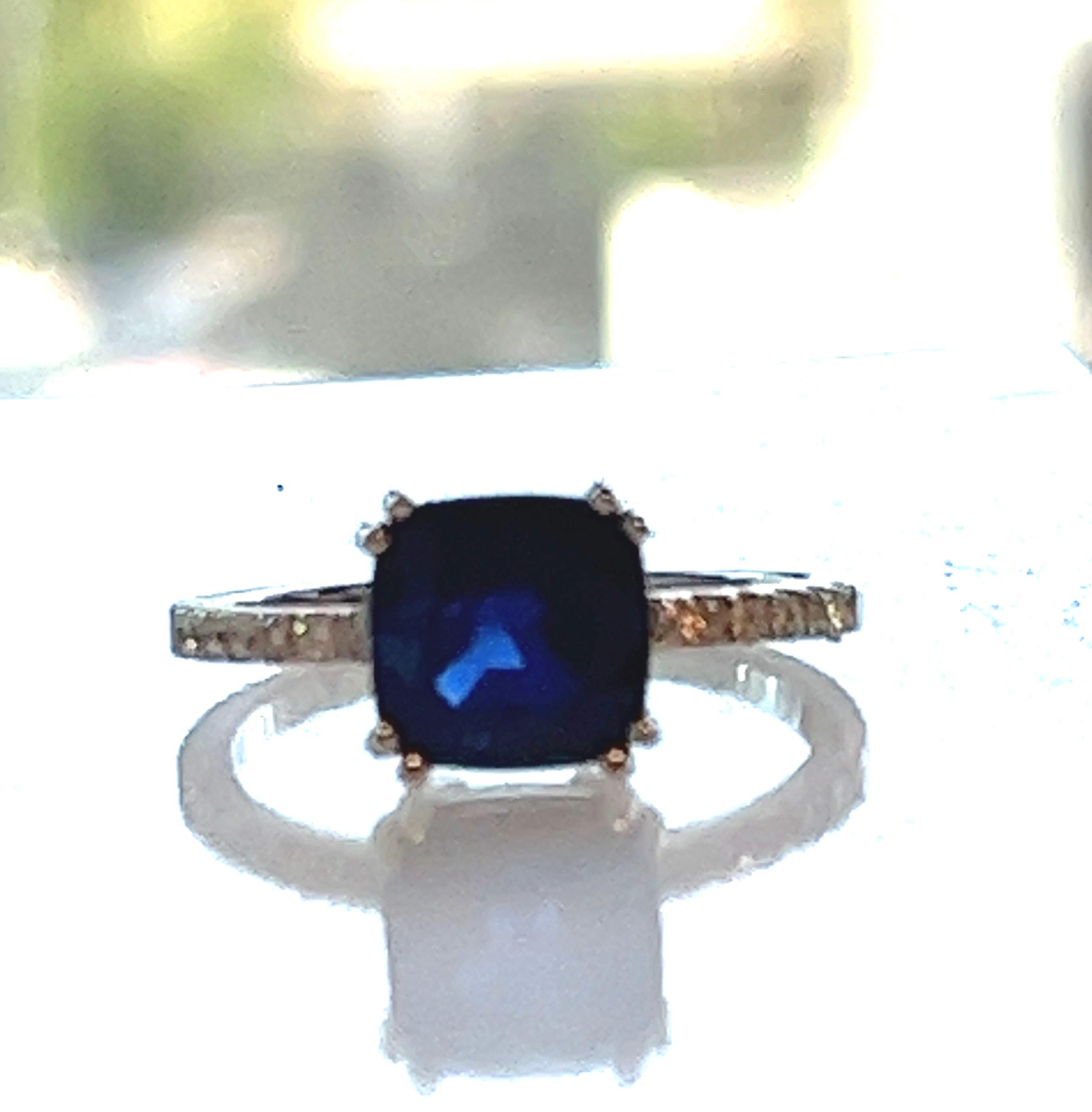 Offered here is a stunning natural earth mined navy blue sapphire, cushion cut weighing 3.14 carats .
Set within 4 double claws basket ring with 6 natural earth mined diamonds bead set on each side of the shank weighing 0.25 carat together,