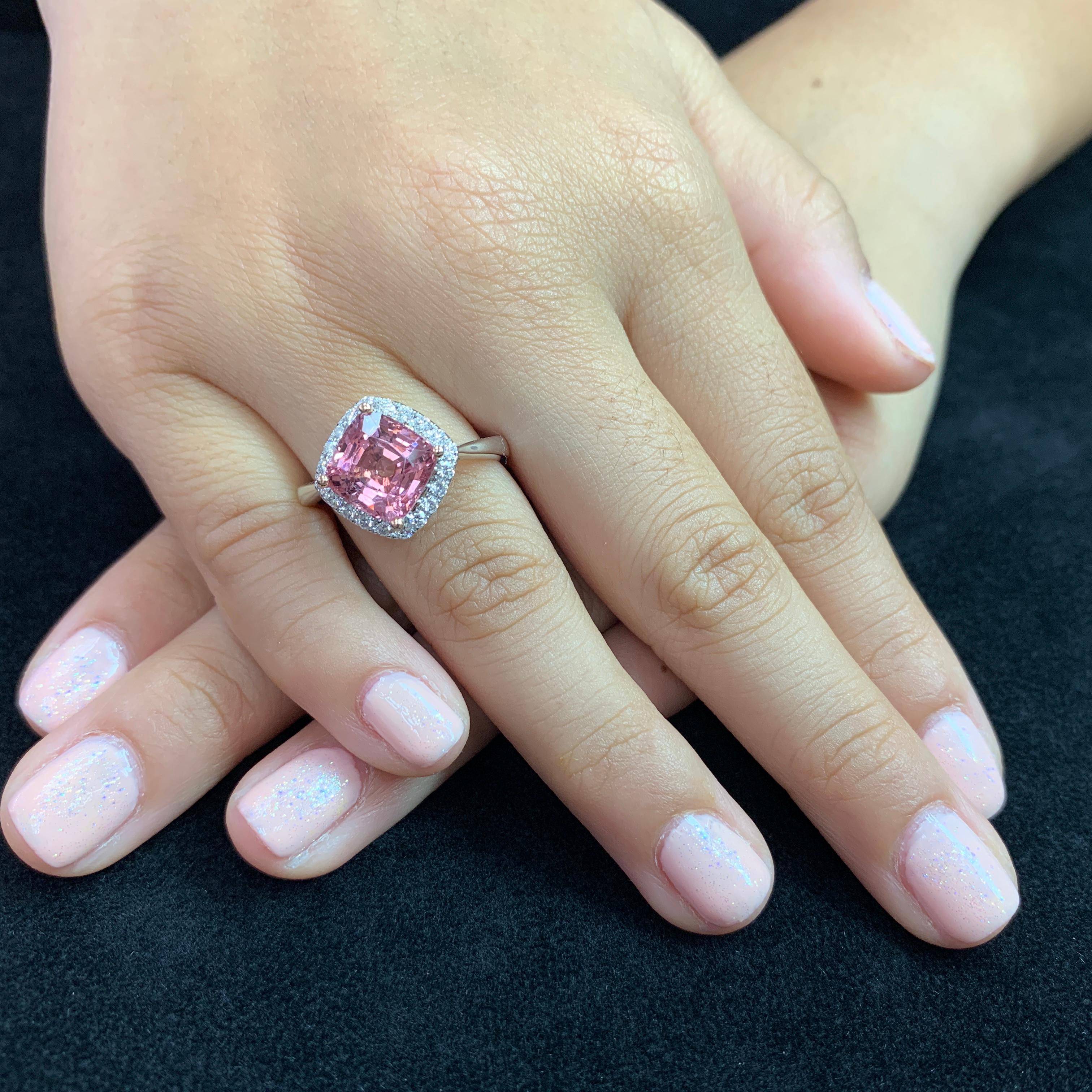Here is a wonderful Spinel ring. The ring is set in 18k white gold and diamonds. There are 0.29Cts of small round diamonds surrounding the center vivid pink Spinel. The Natural Spinel is well cut. The color is crispy and vivid. The ring is full of