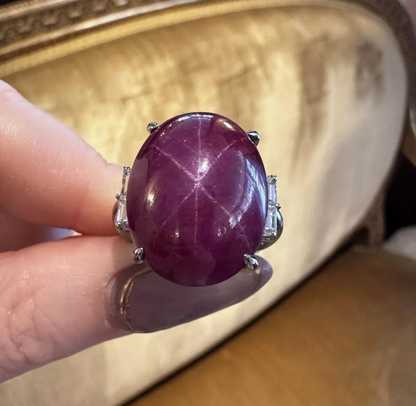 Natural 34.75 ct Star Ruby Cabochon and Diamond Ring in Platinum

Star Ruby and Diamond Ring features a natural Oval Cabochon Star Sapphire with Dark Purplish Pink color weighing 34.75 carats accented by two Baguette Diamonds on either side, all set
