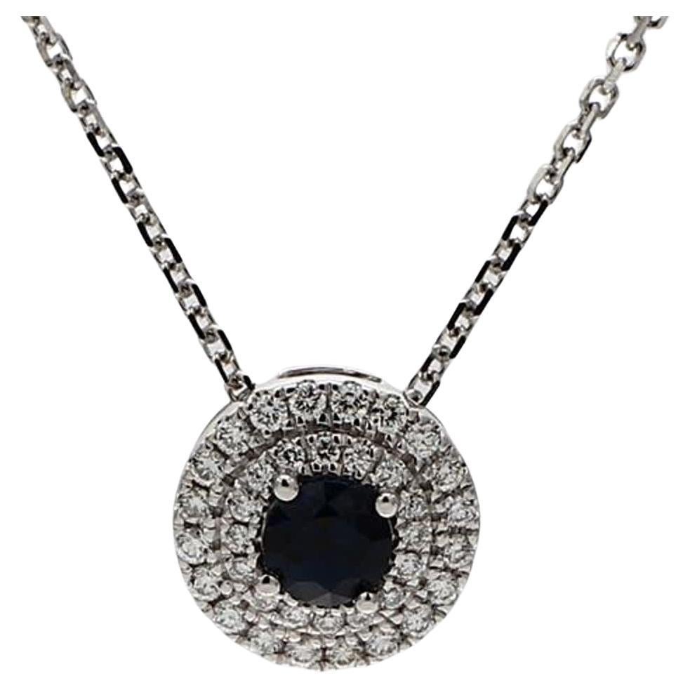 RareGemWorld's classic sapphire pendant. Mounted in a beautiful 18K White Gold setting with a natural round cut blue sapphire. The sapphire is surrounded by natural round white diamond melee in a beautiful double halo. This pendant is guaranteed to