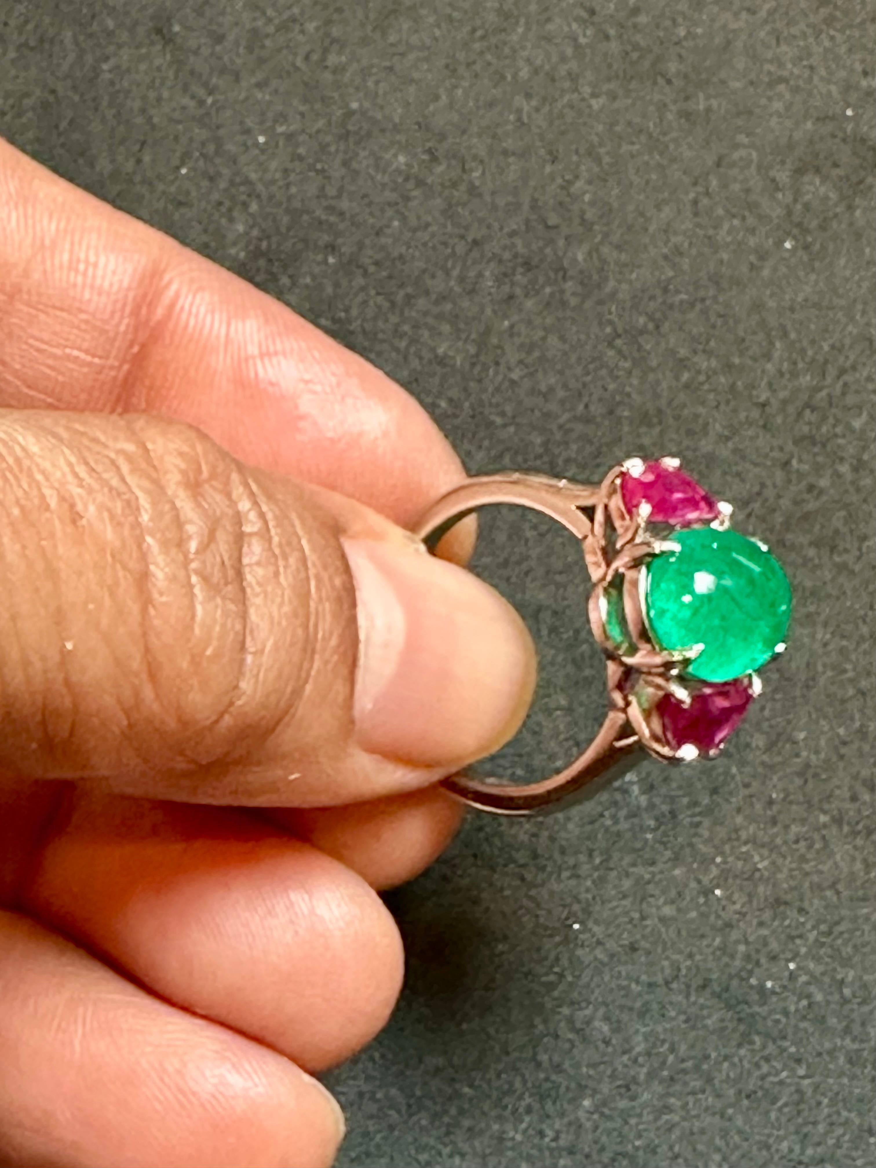 Natural 3.5 Carat Emerald Cabochon & Ruby Ring in Platinum, Estate Size 6
A classic design  ring , Ring Size 6
Approximately 3.5 Carat  emerald Cabochon Absolutely gorgeous emerald , Very desirable color .
Origin Zambia
 Platinum  8.33  gm with