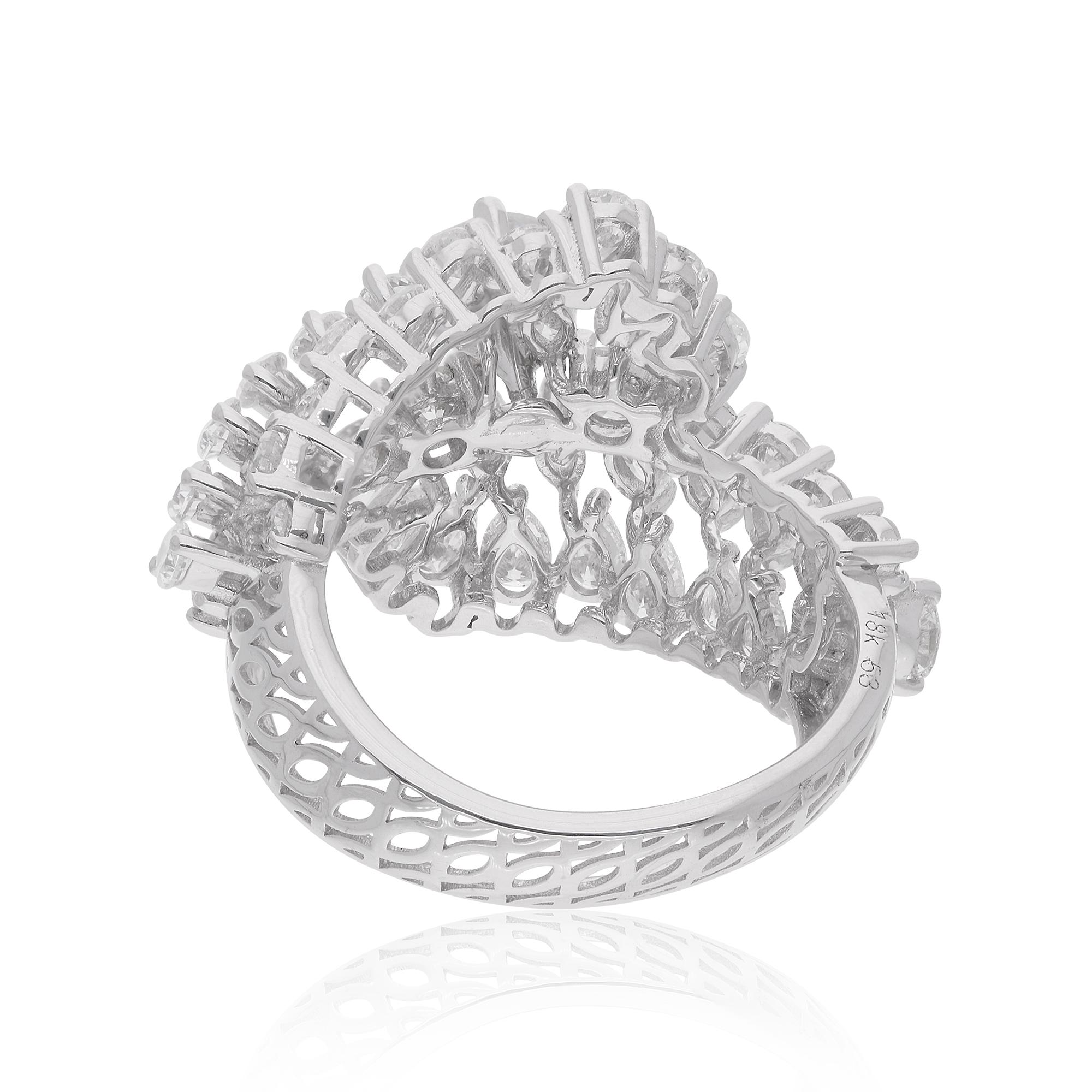 Crafted with meticulous attention to detail, the diamonds are set in a wrap-around design that elegantly encircles your finger, creating a sense of modern elegance and refinement. The lustrous 14 Karat White Gold setting enhances the beauty of the