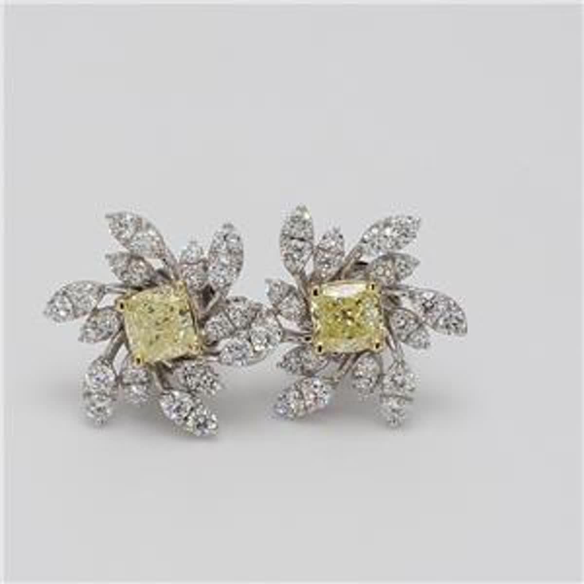 RareGemWorld's classic natural cushion cut yellow diamond earrings. Mounted in a beautiful 18K Yellow and White Gold setting with natural cushion cut yellow diamonds. The yellow diamonds are surrounded by small round natural white diamond melee in a
