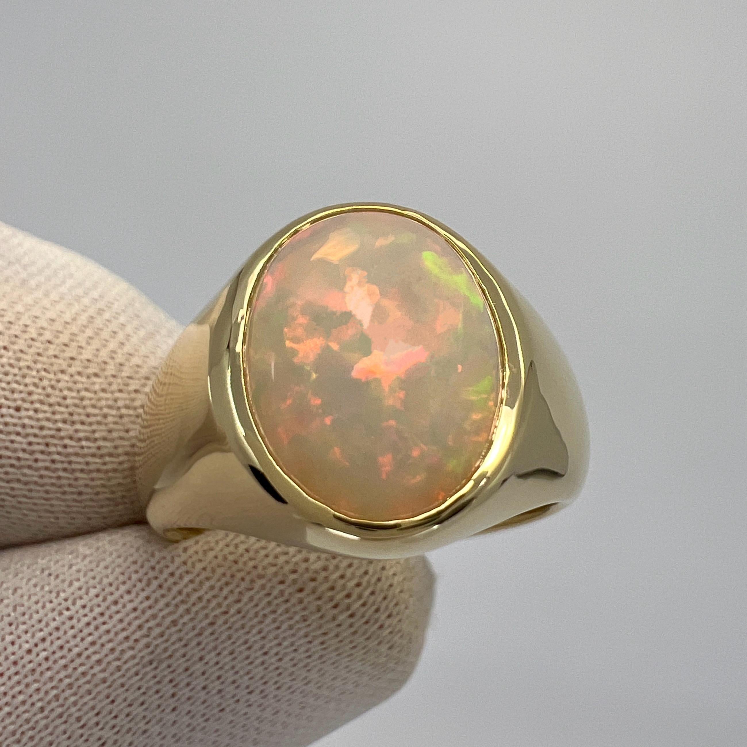 Natural White Ethiopian Opal 9k Yellow Gold Signet Ring.

A stunning 3.80 carat natural white opal with a beautiful play of colour and an excellent oval cabochon cut. Set in a bespoke made 9k yellow gold rubover bezel signet ring. 
This opal has a
