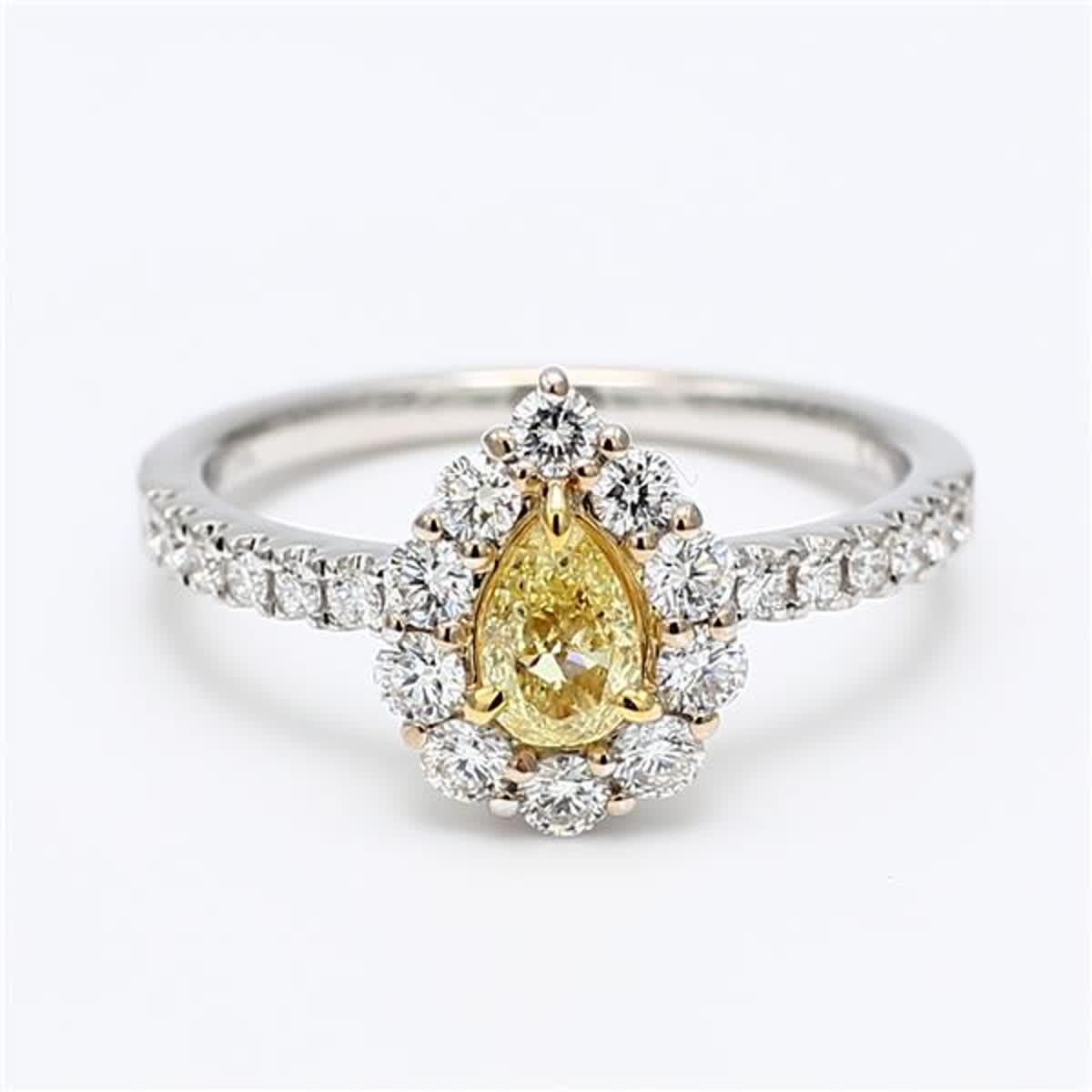 RareGemWorld's classic diamond ring. Mounted in a beautiful 18K Yellow and White Gold setting with a natural pear cut yellow diamond. The yellow diamond is surrounded by small round natural white diamond melee. This ring is guaranteed to impress and