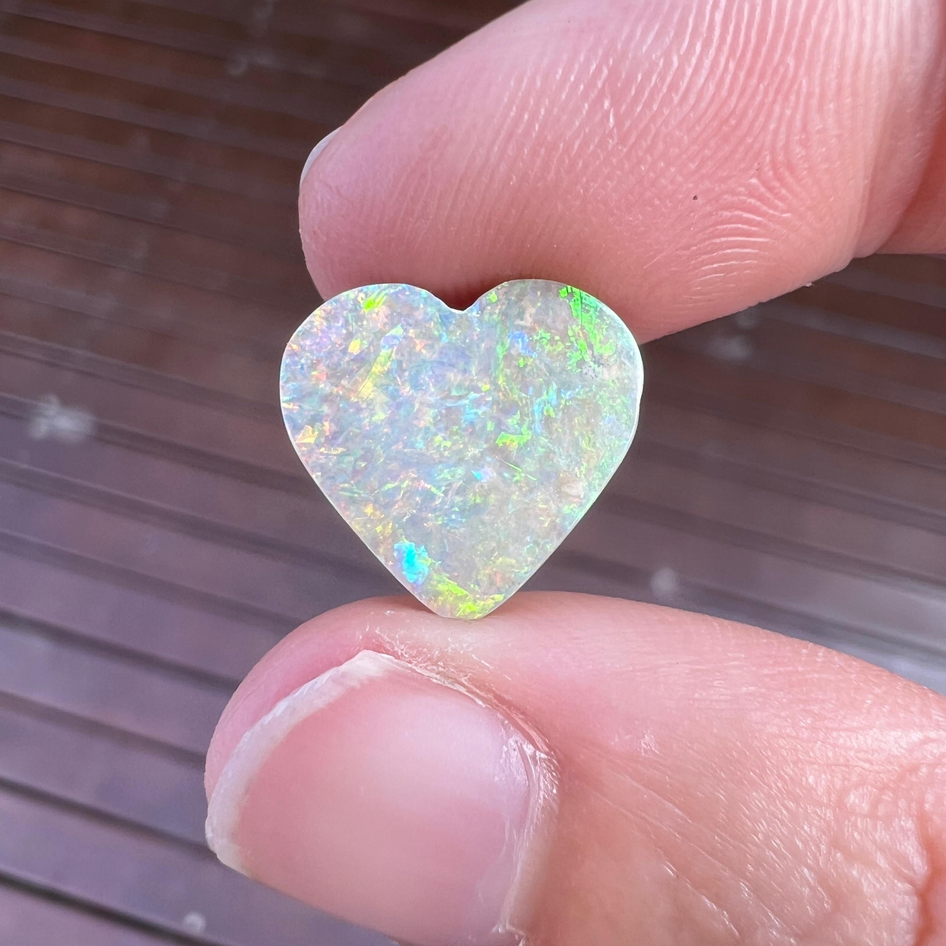 This lovely 4.14 Ct Australian boulder opal was mined by Sue Cooper at her Yaraka opal mine in western Queensland, Australia in 2021. Sue processed the rough opal herself and cut into into an heart shape. We especially love the gold, orange and blue