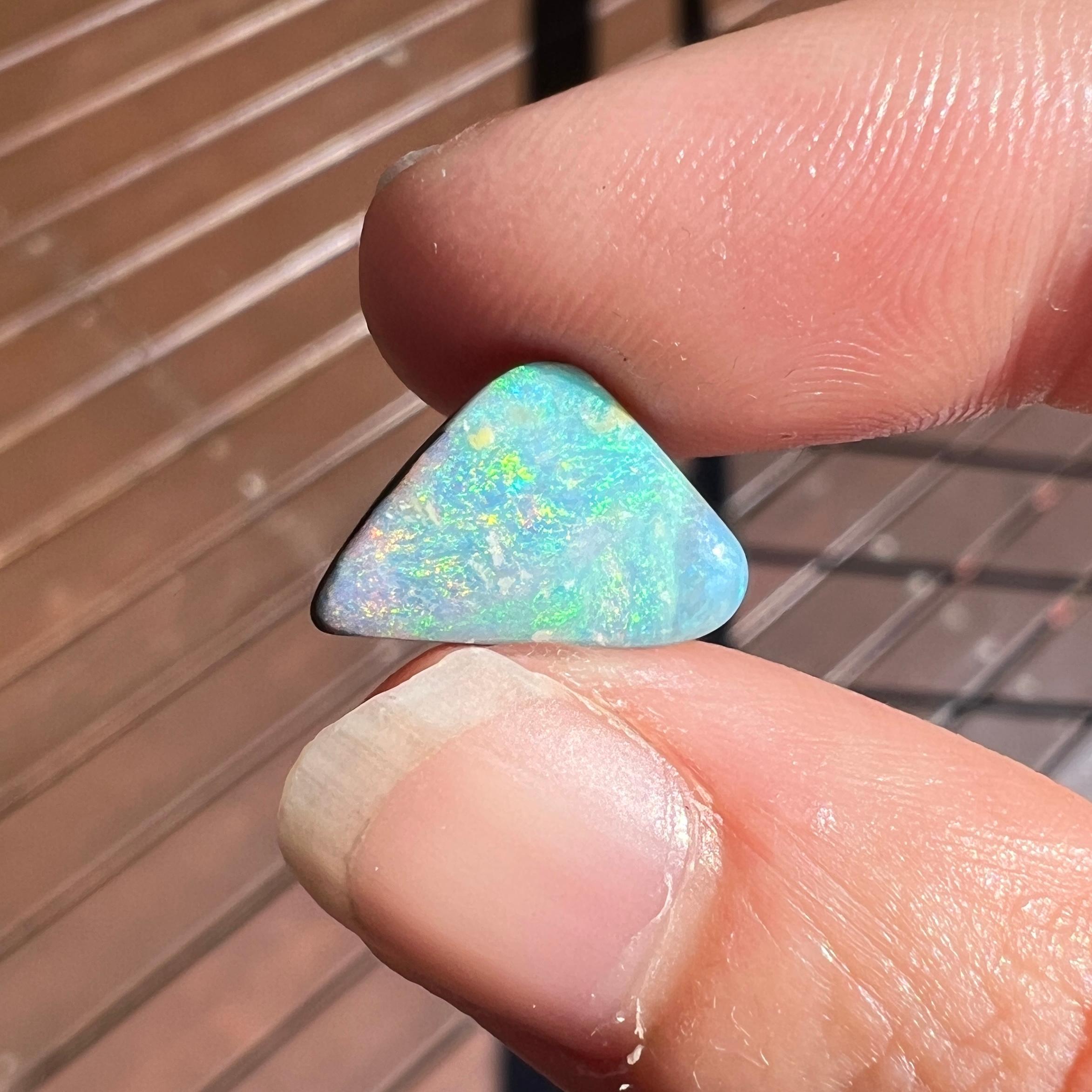 This lovely 4.15 Ct Australian boulder opal was mined by Sue Cooper at her Russells opal mine in western Queensland, Australia in 2022. Sue processed the rough opal herself and cut into into a free-form shape. We love how the pink, green and blue