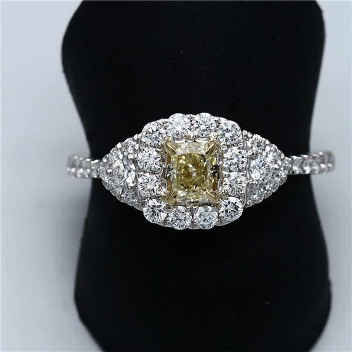Rare radiant natural yellow diamond surrounded with natural round white diamonds. This ring is designed to be in a simple but intriguing setting with a single array of diamonds surrounding the centerstone as well as diamonds along the band. Can be