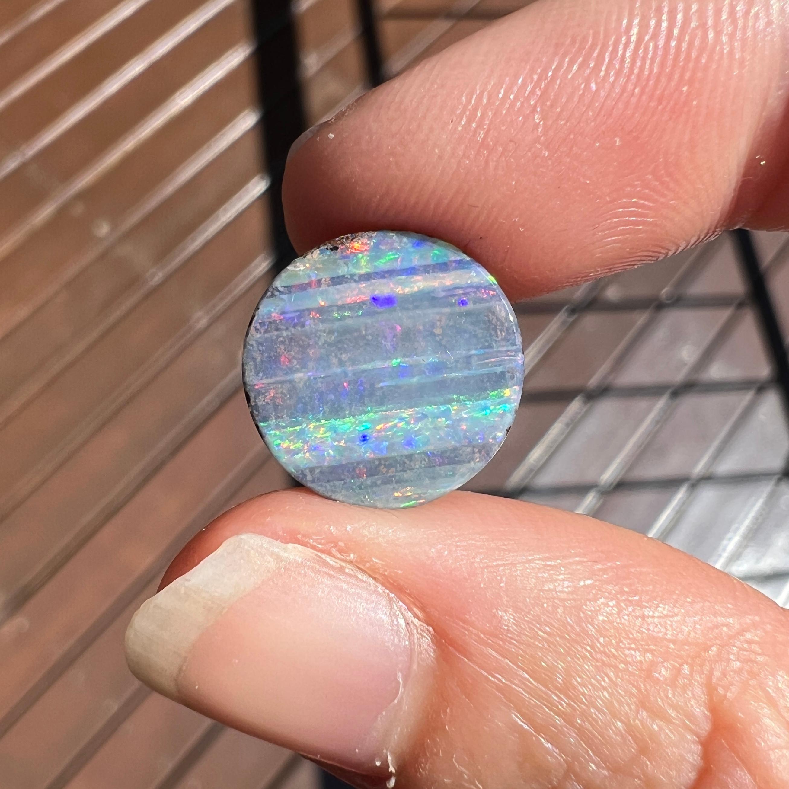 This stunning 4.28 Ct Australian boulder opal was mined by Sue Cooper at her Yaraka opal mine in western Queensland, Australia in 2023. Sue processed the rough opal herself and cut into into a modern circle shape. We love how it has a rainbow