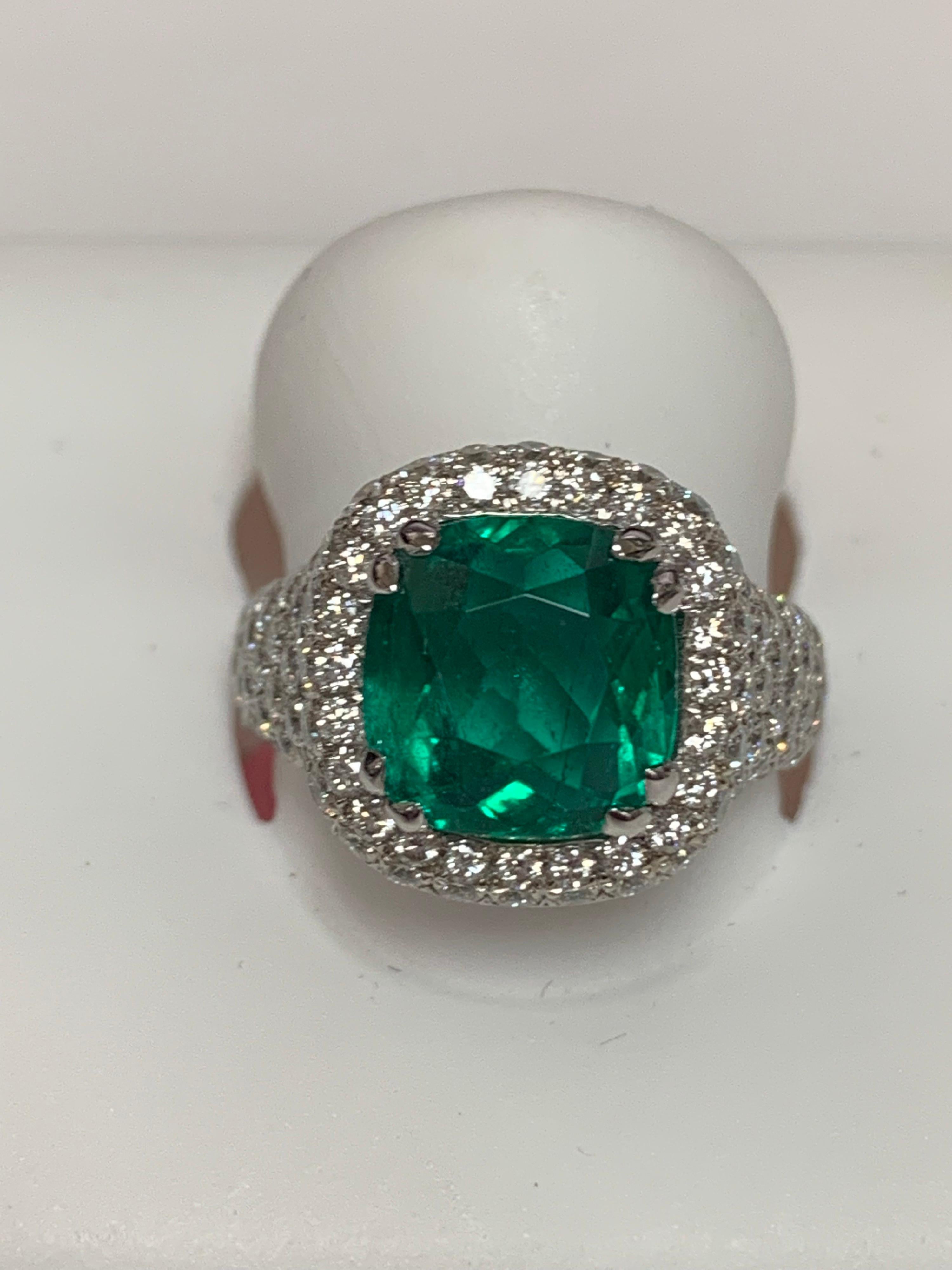 Natural 4.32 Carat Cushion Emerald and round white diamonds 1.69 Carat set in 14 Karat gold is one of a kind hand crafted ring, The size of the ring is 7 and can be resized if needed.