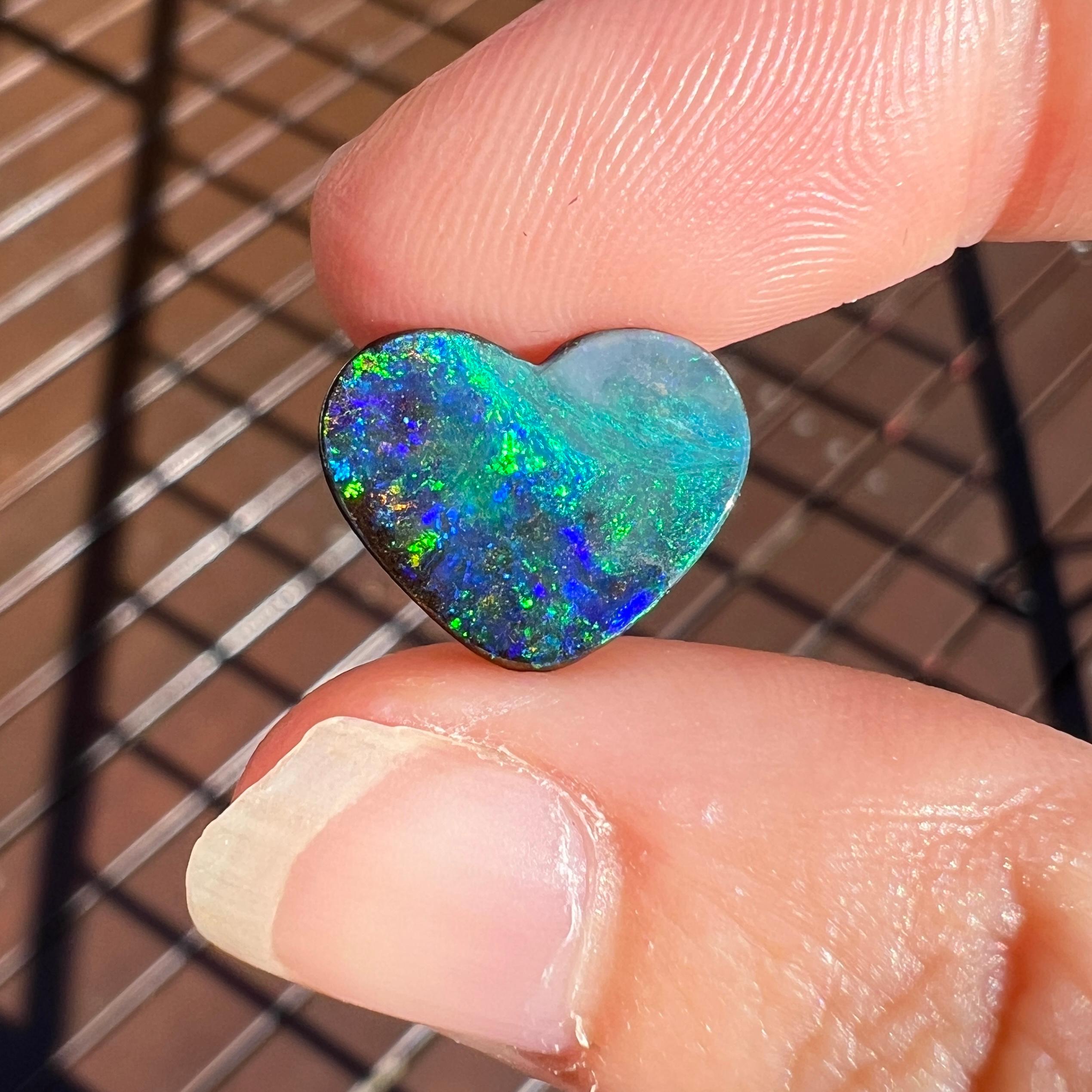 Introducing our exquisite black boulder heart opal! This rare 4.40 Ct Australian black boulder opal was mined by Sue Cooper at her Yaraka opal mine in western Queensland, Australia in 2021. Sue processed the rough opal herself and selected to cut