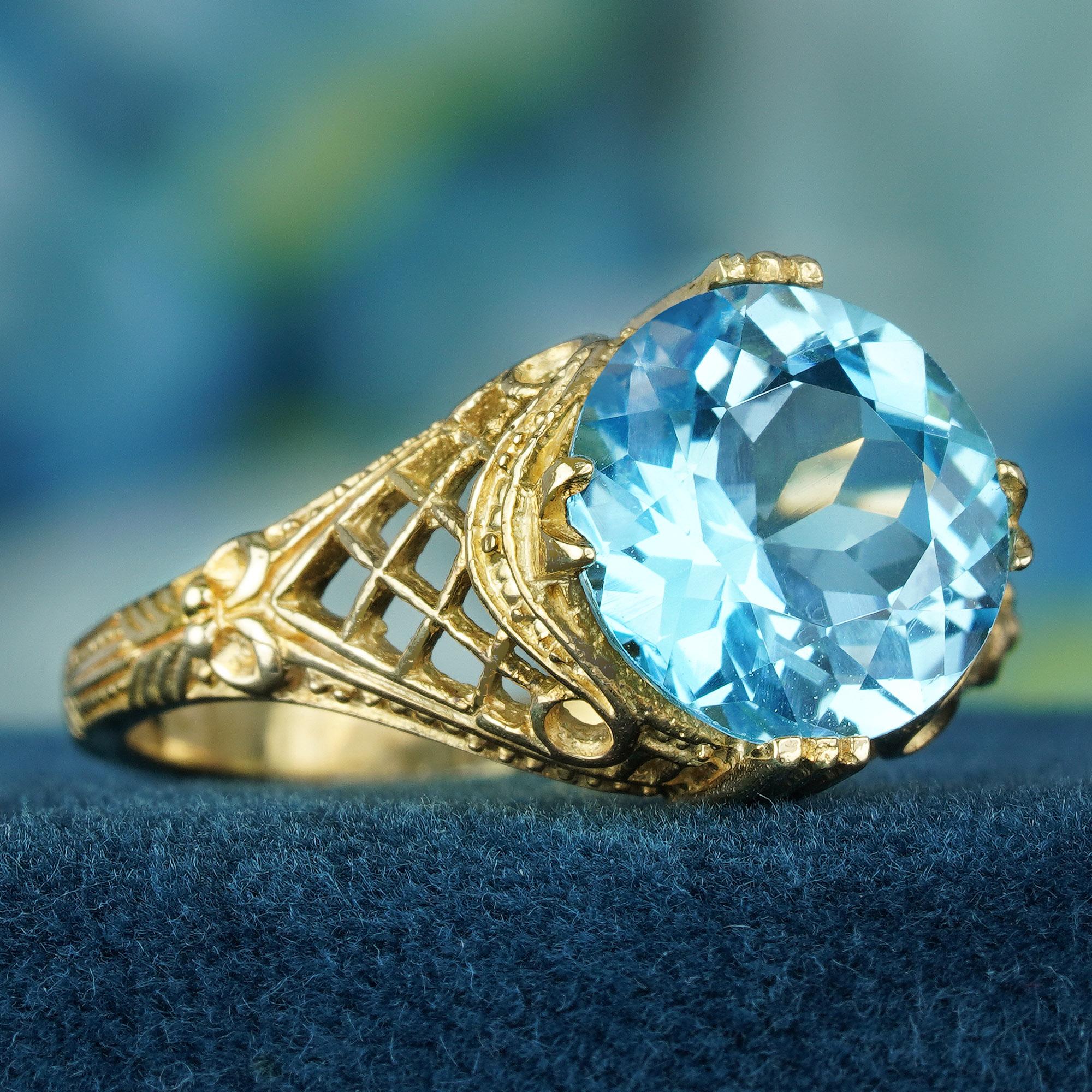 While boasting captivating details, the 4.5 carat blue topaz ring effortlessly radiates an enduring sense of elegance. The timeless allure is achieved through the combination of a traditional yellow gold band, an elaborate filigree pattern, and the
