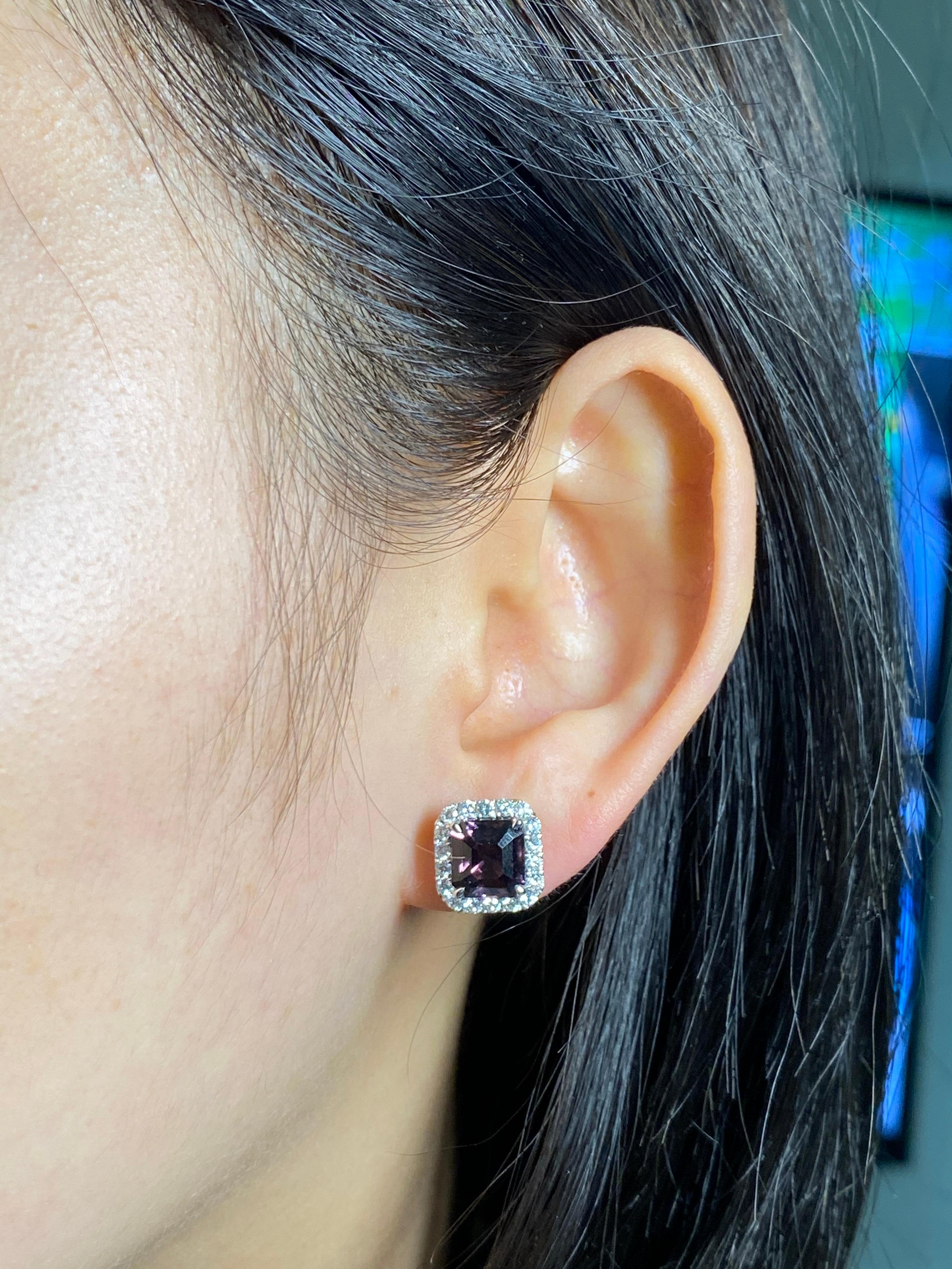 Here is a pair of purple Asscher step cut spinel and diamond halo earrings. The earrings are set in 18k white gold and diamonds. There are 0.67 Cts of full cut diamonds of high quality. Two natural spinels about 2.36 cts each totaling 4.73 cts make
