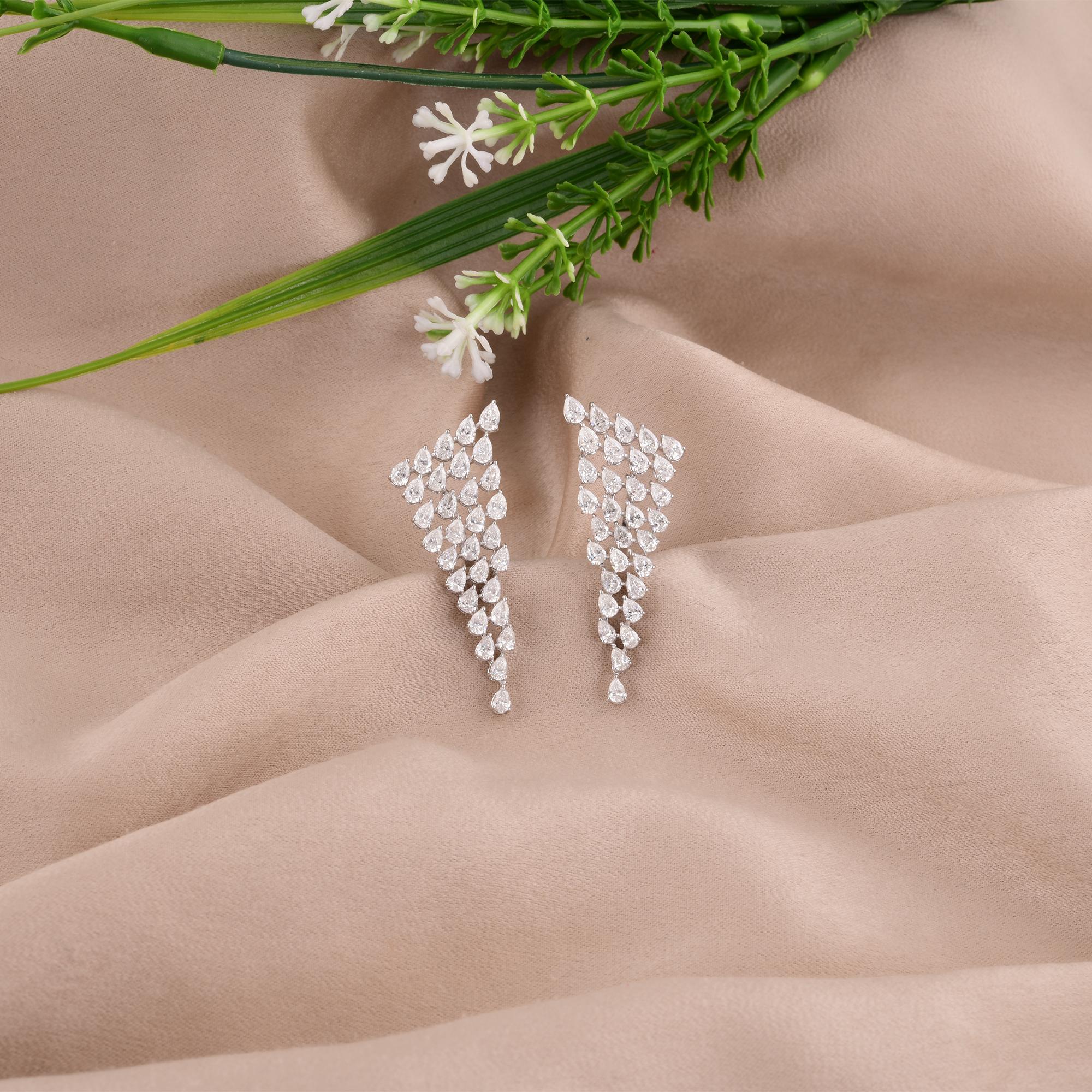 Crafted from 14 karat white gold, a precious metal celebrated for its luminous purity and enduring elegance, the setting of these earrings provides the perfect backdrop for the resplendent diamonds. The sleek and polished white gold enhances the