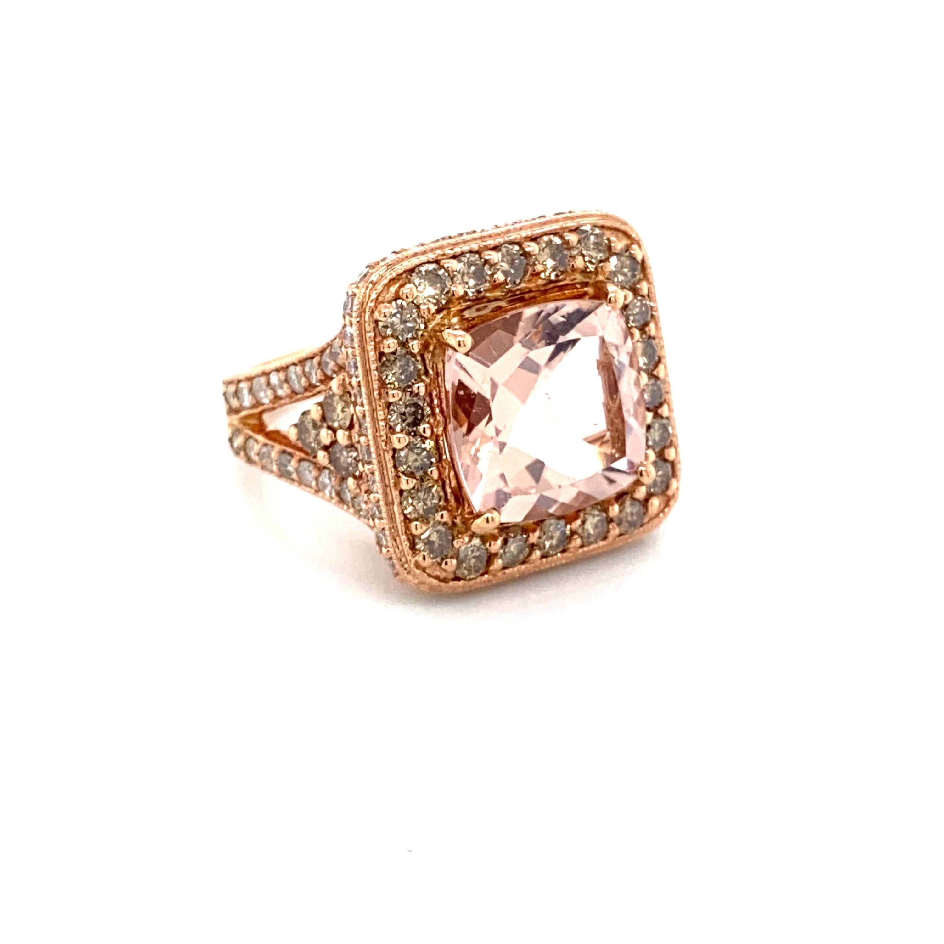 This is a stunning natural morganite and diamond halo ring set in solid 14K rose gold. The natural 11MM Cushion cut 5.10ct morganite has an excellent peachy pink color (5.10 carats of a AAA quality gem!) and is surrounded by a halo of round cut