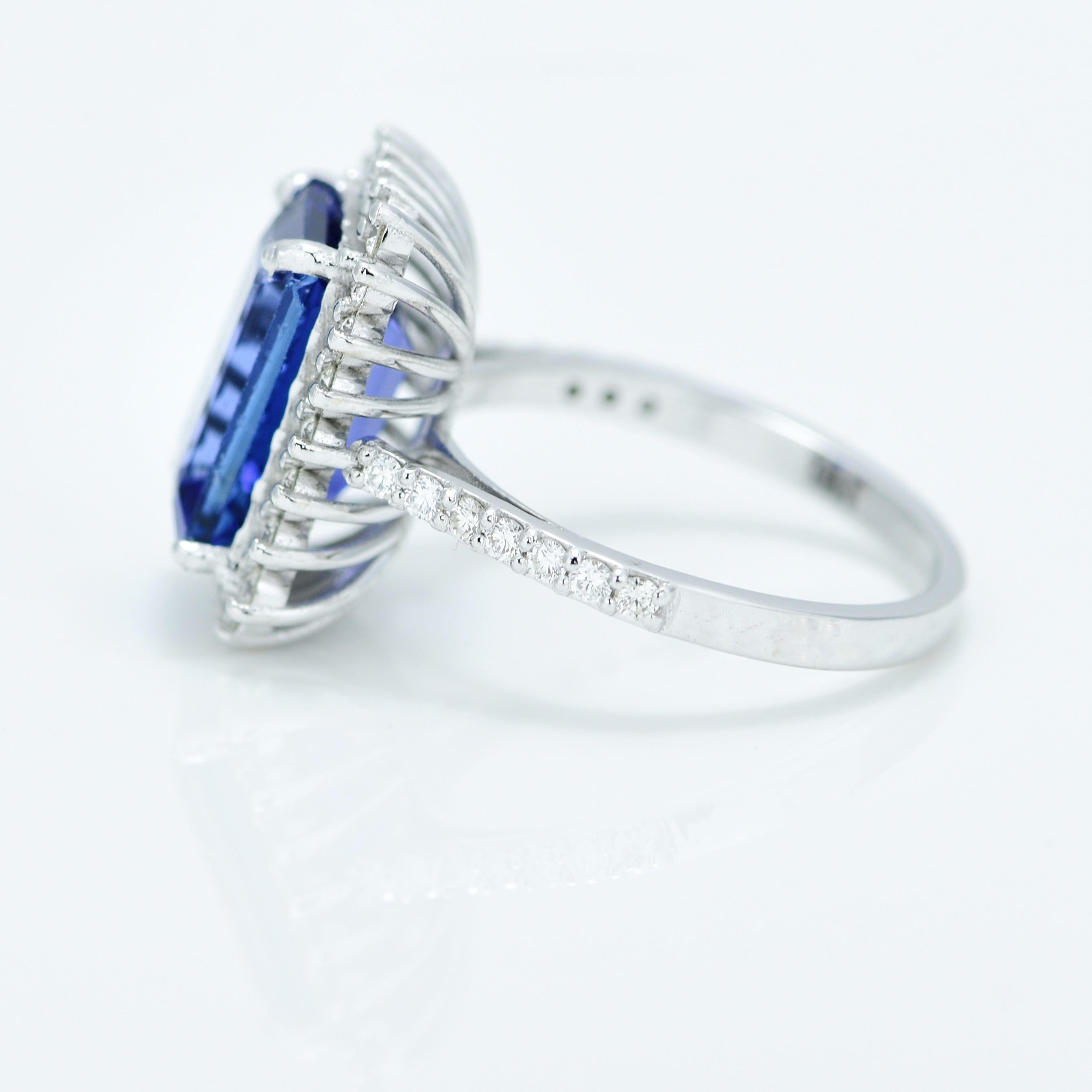 Stunning Violetish Blue Tanzanite and Diamond halo ring.

Centre Stone - Natural Tanzanite, 
Centre Stone Weight - 5.19 Carat, 
Centre Stone Shape & Cut - Emerald Step Cut
 
Total Number of Diamonds - 38, 
Diamonds Carat Weight - 0.56 carat
Diamond
