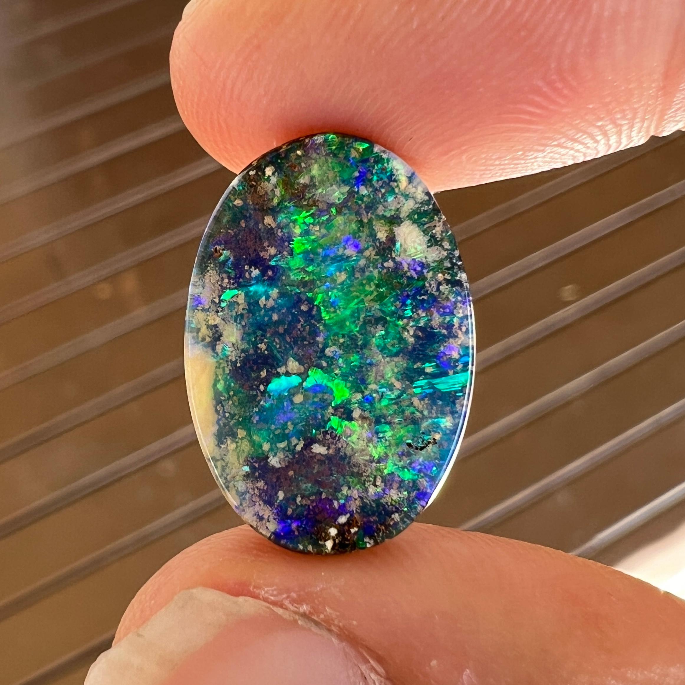 This amazing 5.89 Ct Australian black boulder opal was mined by Sue Cooper at her Yaraka opal mine in western Queensland, Australia in 2023. Sue processed the rough opal herself and cut into into a classic oval shape. We love how bright its green,