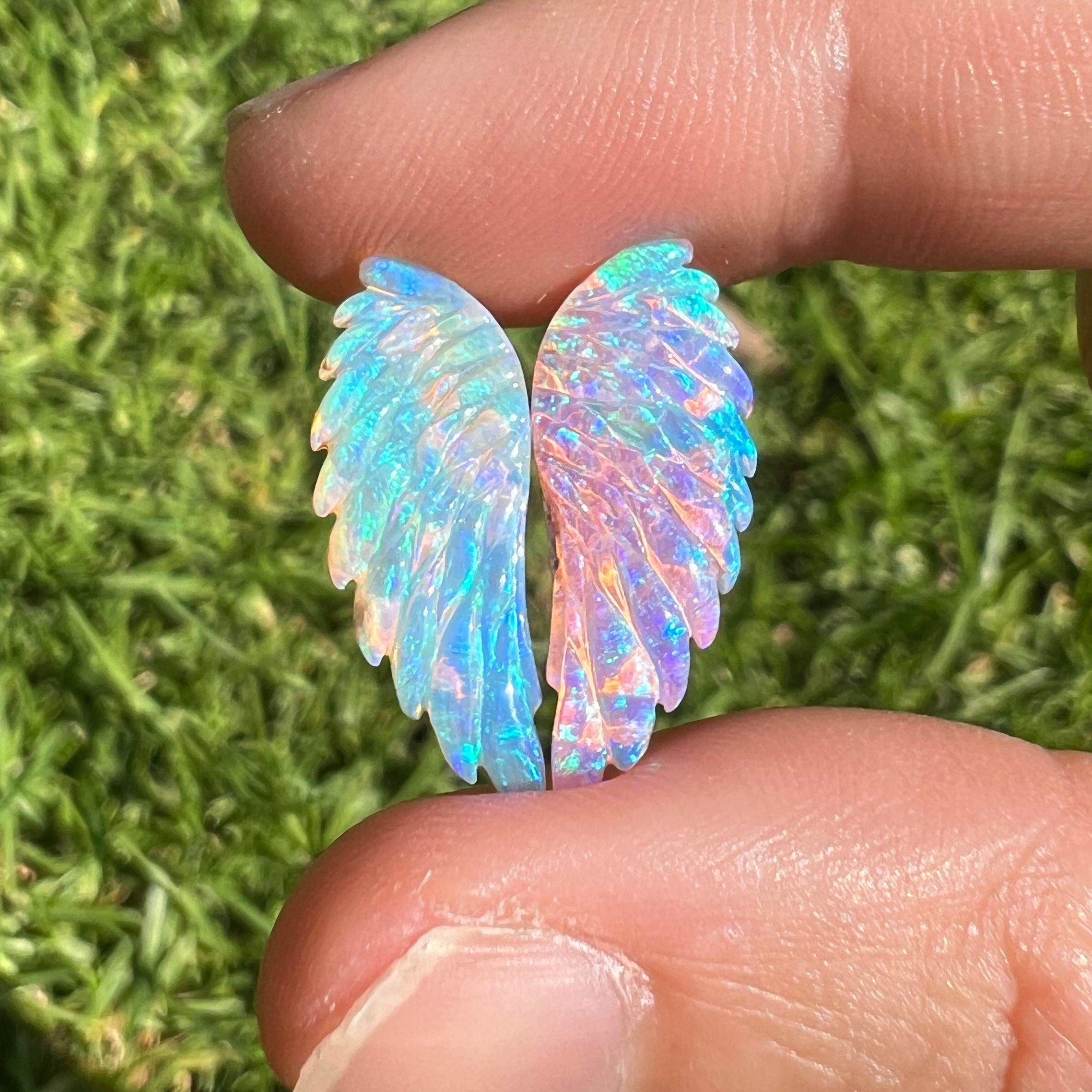 This beautiful 12.35 Ct natural Australian gem crystal opal, carved into a pair of angel wings, is a truly exceptional addition to any collection, mined by Sue Cooper herself. Its rarity, coupled with the amazing winged carving, captivates