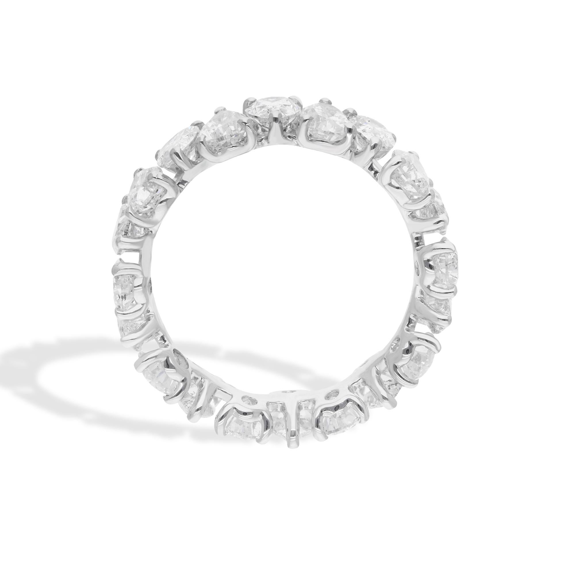 Set in a continuous band of lustrous white gold, these magnificent diamonds encircle the finger in an eternal embrace, symbolizing everlasting love and commitment. The pear-shaped cut of the diamonds adds a touch of sophistication and refinement to