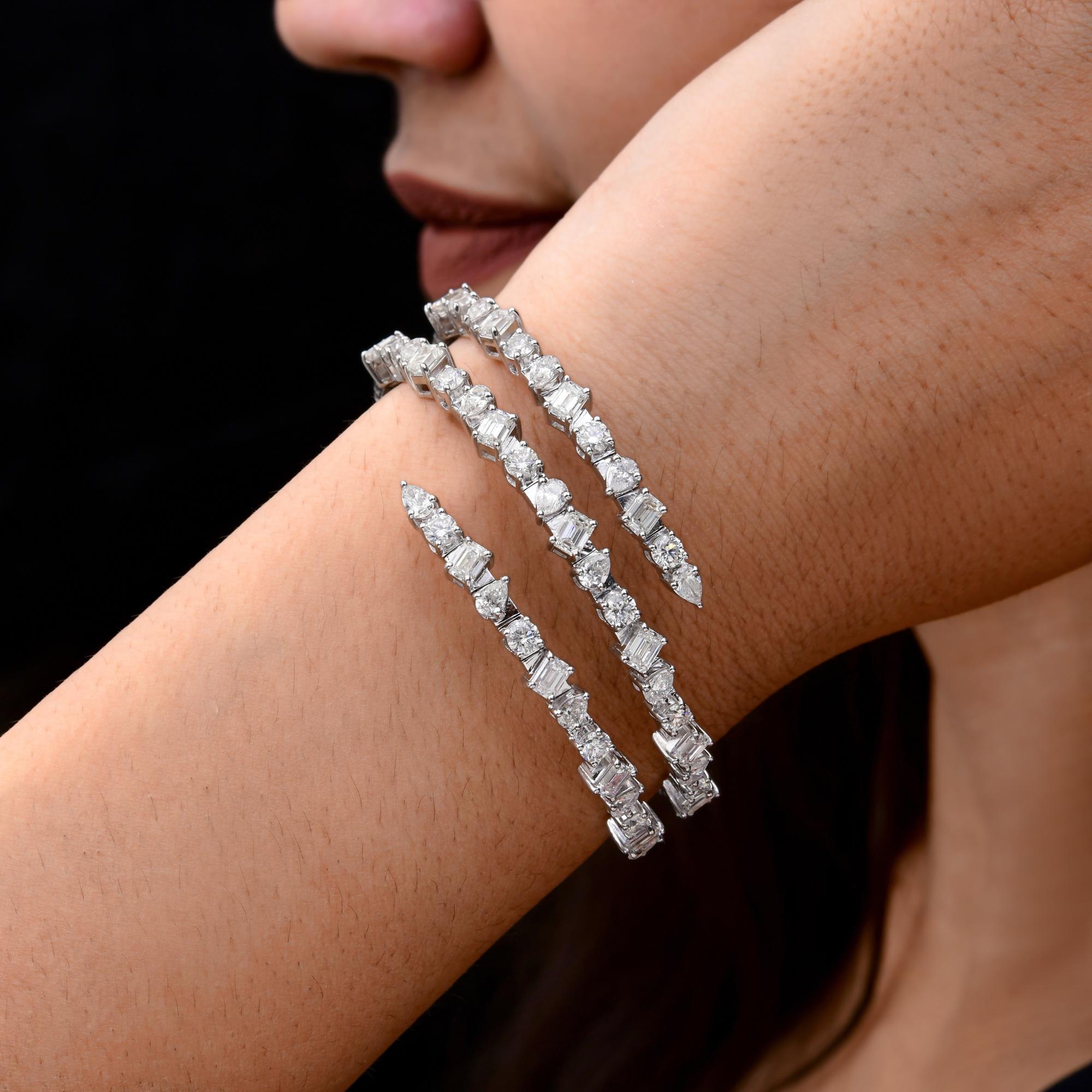 This Natural 8.19 Carat SI/H Multi Shape Diamond 14 Karat White Gold Wrap Bracelet features mixed cut diamond set in three wrap in a spiral design. 
Diamonds are a universal symbol of eternity and strength. It is a April Birthstone and perfect for