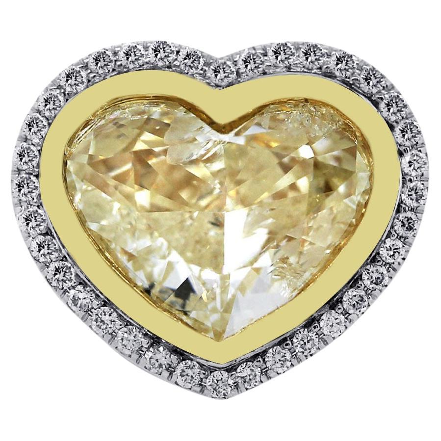 18k Two Tone Gold 8.32ct Heart Shaped Fancy Yellow Diamond Ring

This Natural, Fancy Yellow, Heart-shaped diamond is set in 18-karat yellow and white gold. The main diamond is a bezel-set fancy yellow diamond weighing approximately 8.32 carats. This