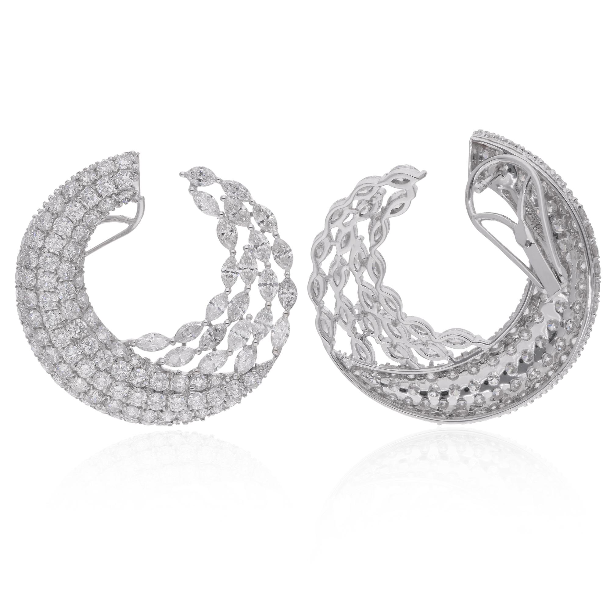 At the center of each hoop earring, a resplendent array of marquise and round-cut diamonds commands attention. These diamonds, totaling an impressive 8.76 carats, are meticulously selected for their exceptional brilliance, clarity, and fire. Each
