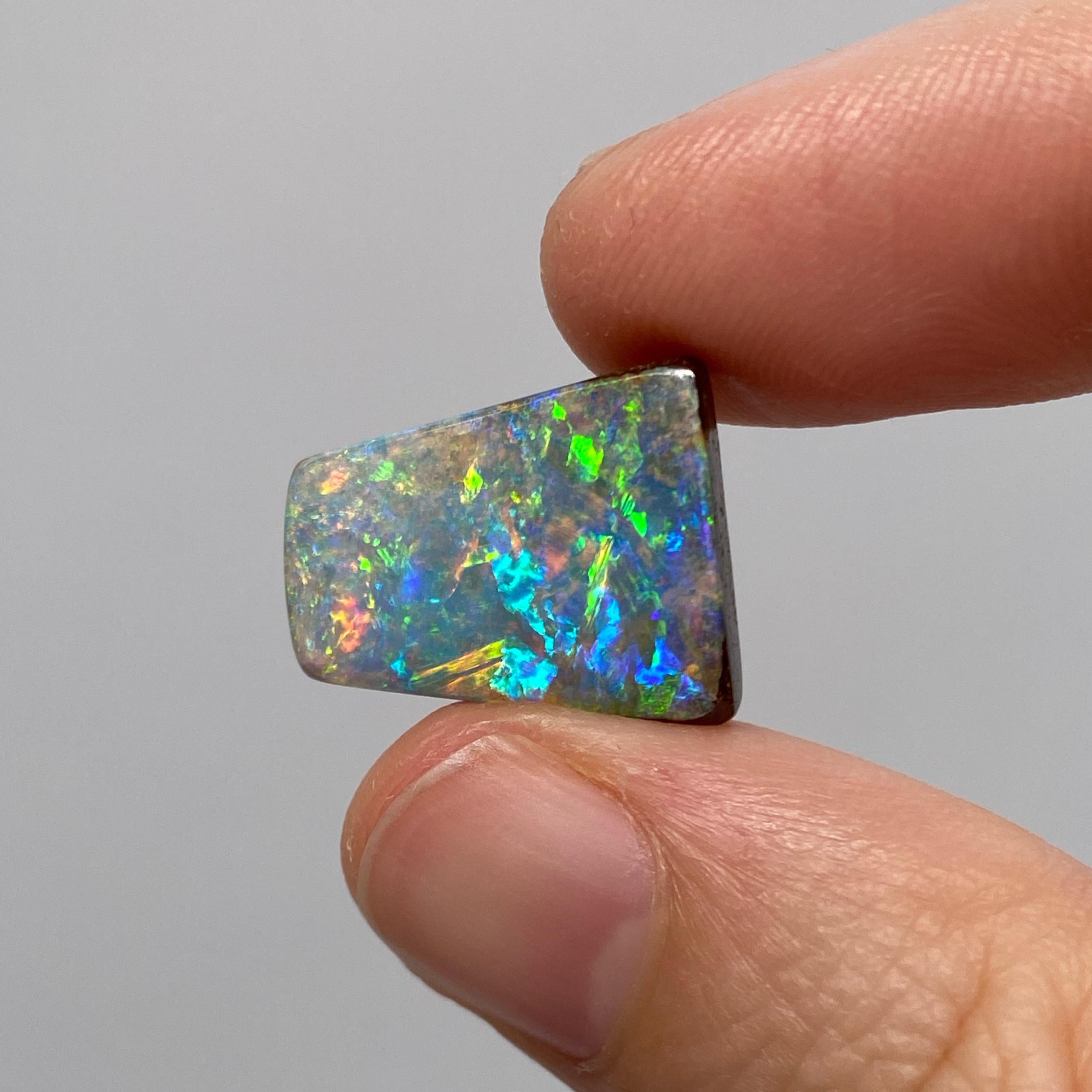 This gem grade natural solid Australian boulder opal was mined in western Queensland, Australia by a female opal miner. It has all the colors of the rainbow present and a great play-of-color. It is very bright and has a lighter (N6 / N7) body tone