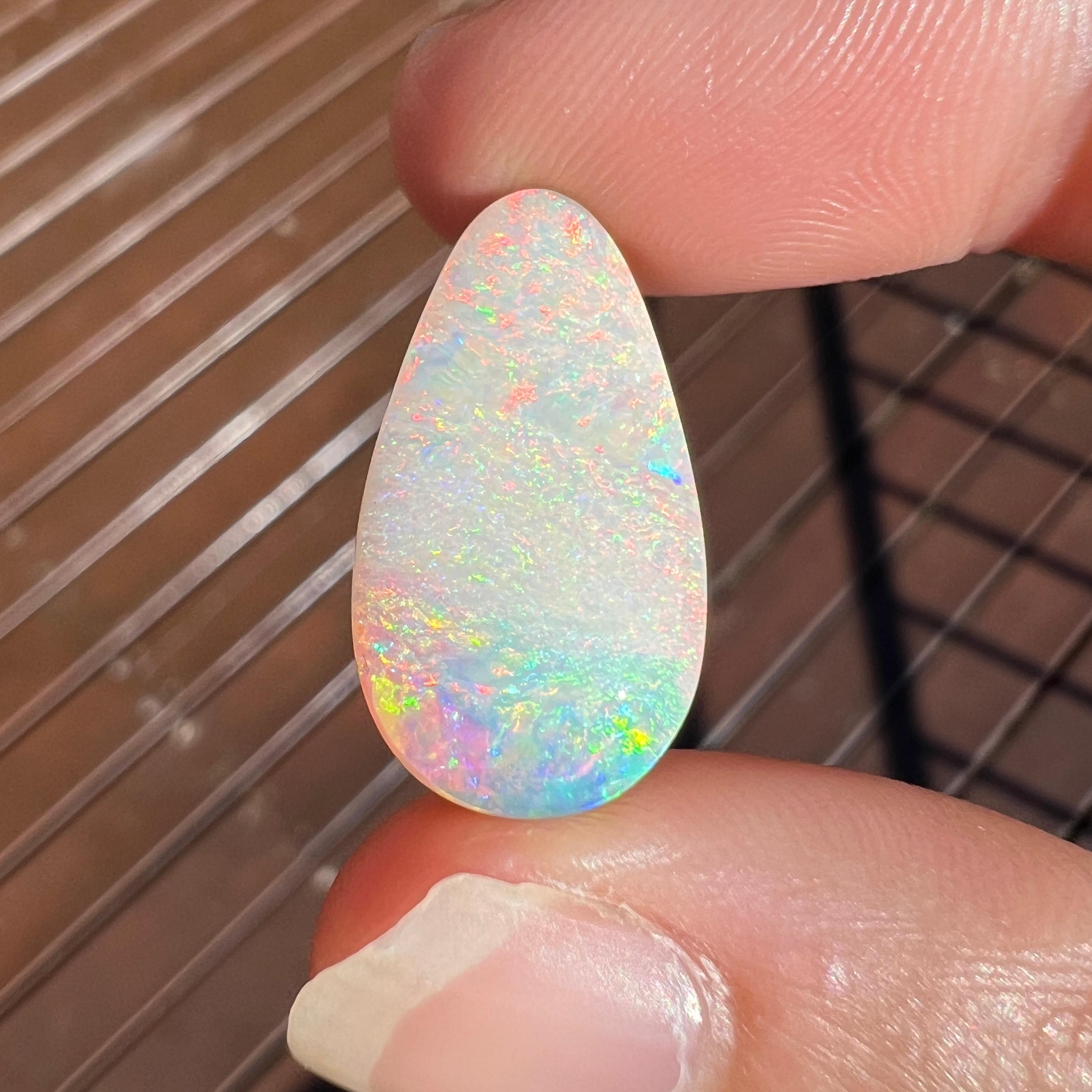 This lovely 9.42 Ct Australian boulder opal was mined by Sue Cooper at her Yaraka opal mine in western Queensland, Australia in 2022. Sue processed the rough opal herself and cut into into an elongated teardrop shape. We especially love the pink and