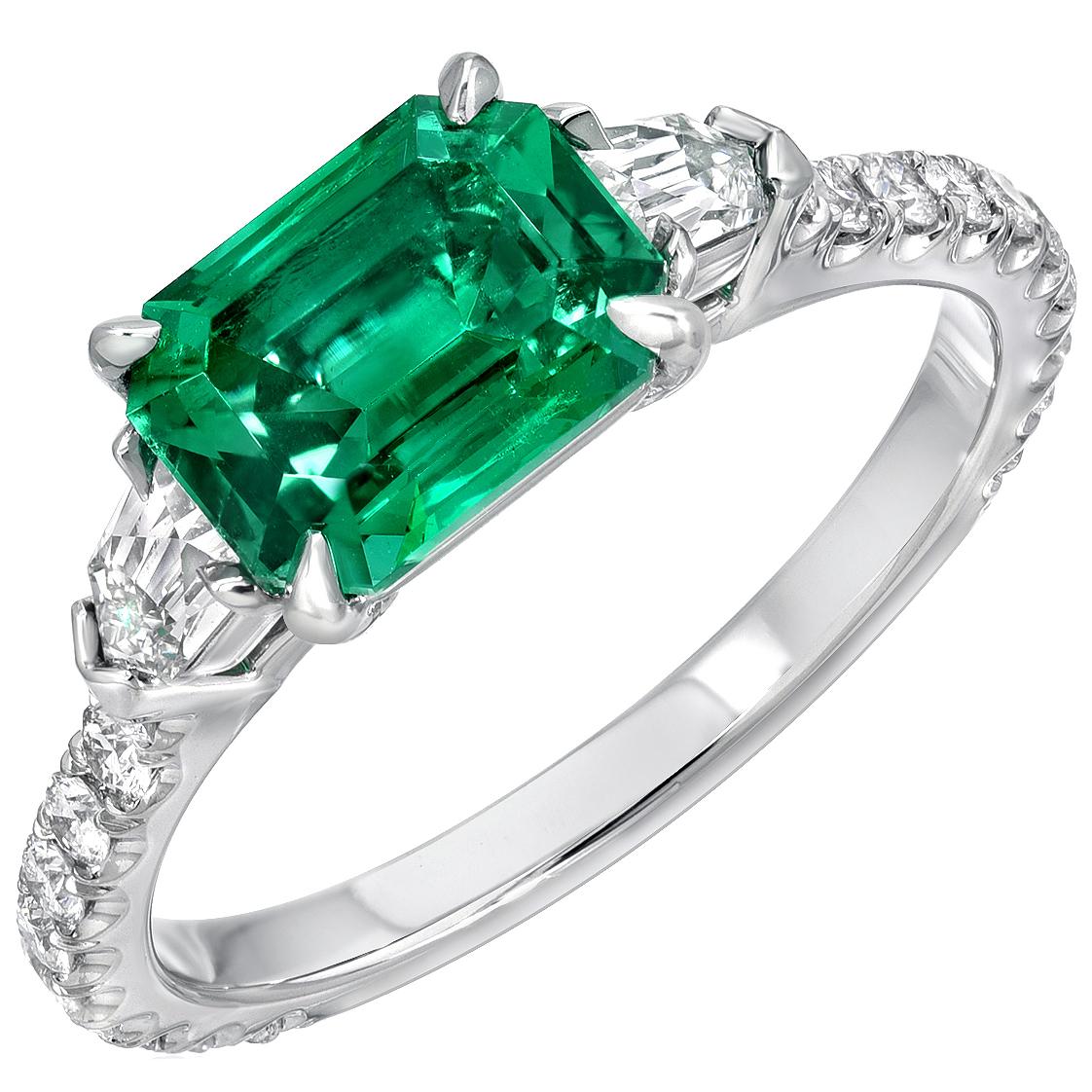 Exceptional platinum ring featuring a collection-quality 1.47 carat, no oil, emerald-cut Emerald, from Panjshir Afghanistan. This Emerald is flanked by a pair of 0.27 carat total, French-Cut bullet shaped diamonds, E color and VS1 clarity, and