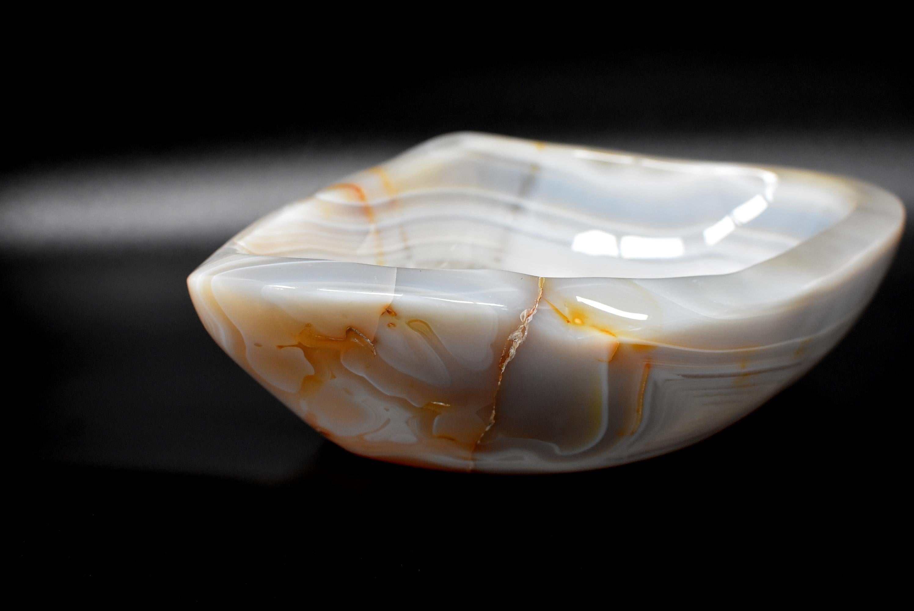 A stunning, large, 4.6 lb, all natural agate bowl with fantastic swirls and crystals. Its mellow yet luminous luster combined with fascinating crystals makes it a remarkable center piece. Its sophisticated taupe color suits any elegant interior.