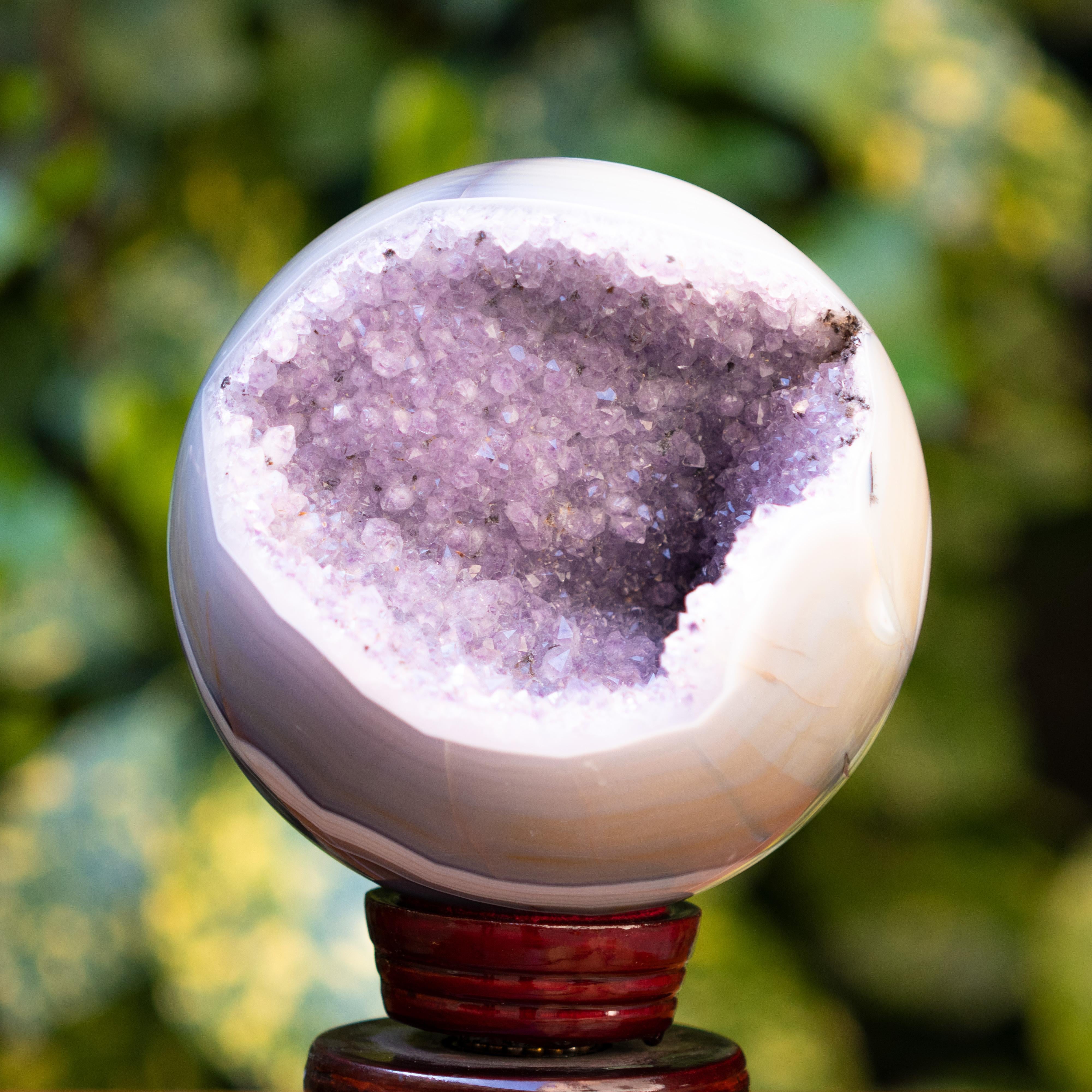 This Crystal Sphere is composed of light purple Agate geode and druze Amethyst minerals which are one of the most powerful crystal healers; focused in growth and stability. A crystal sphere emits a very high frequency of harmony and positive energy