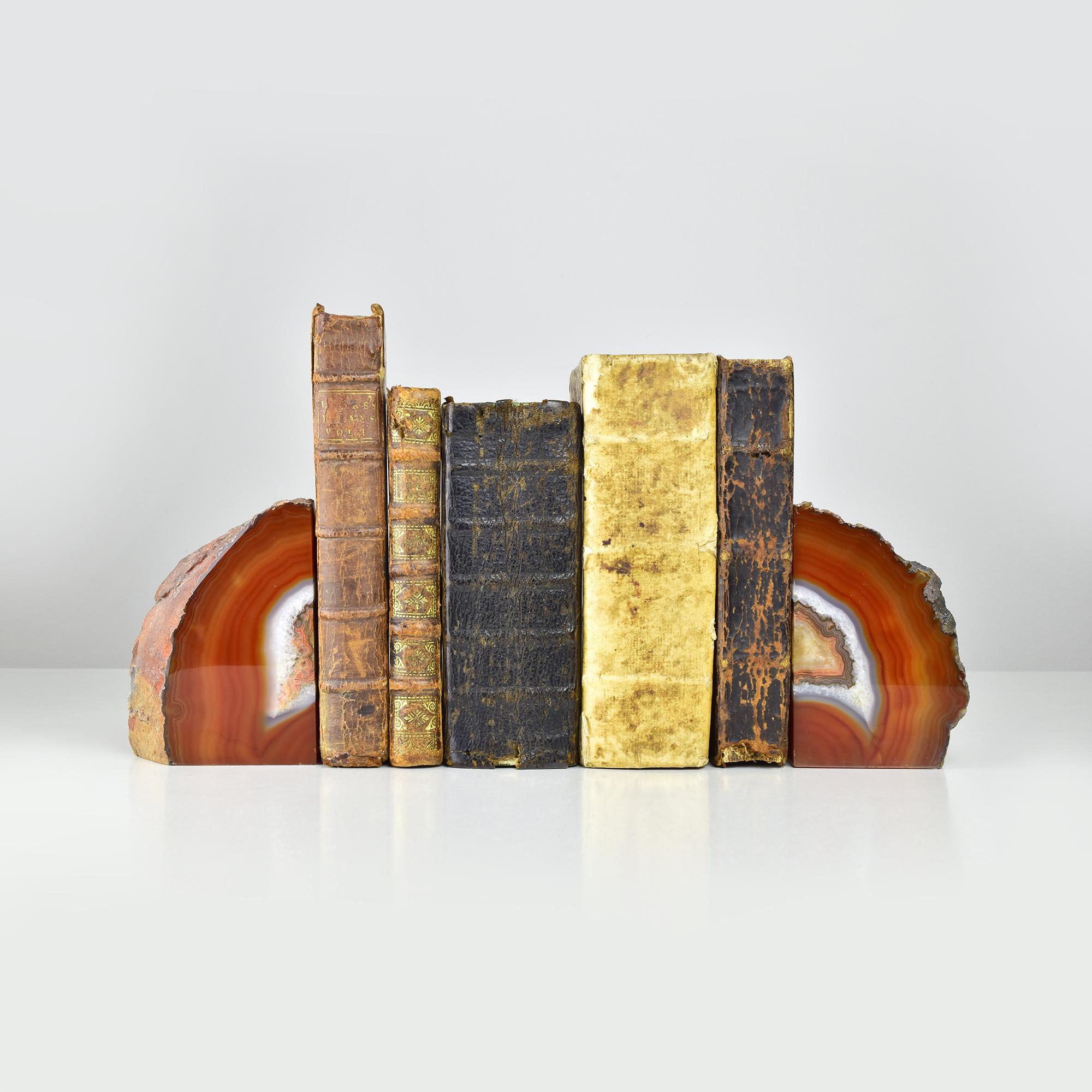 Discover the allure of nature with these stunning agate geode quartz bookends. Each piece is uniquely crafted from semi-precious gemstones, showcasing beautiful, swirling patterns in rich tones of red, orange, and earthy hues. The polished surfaces