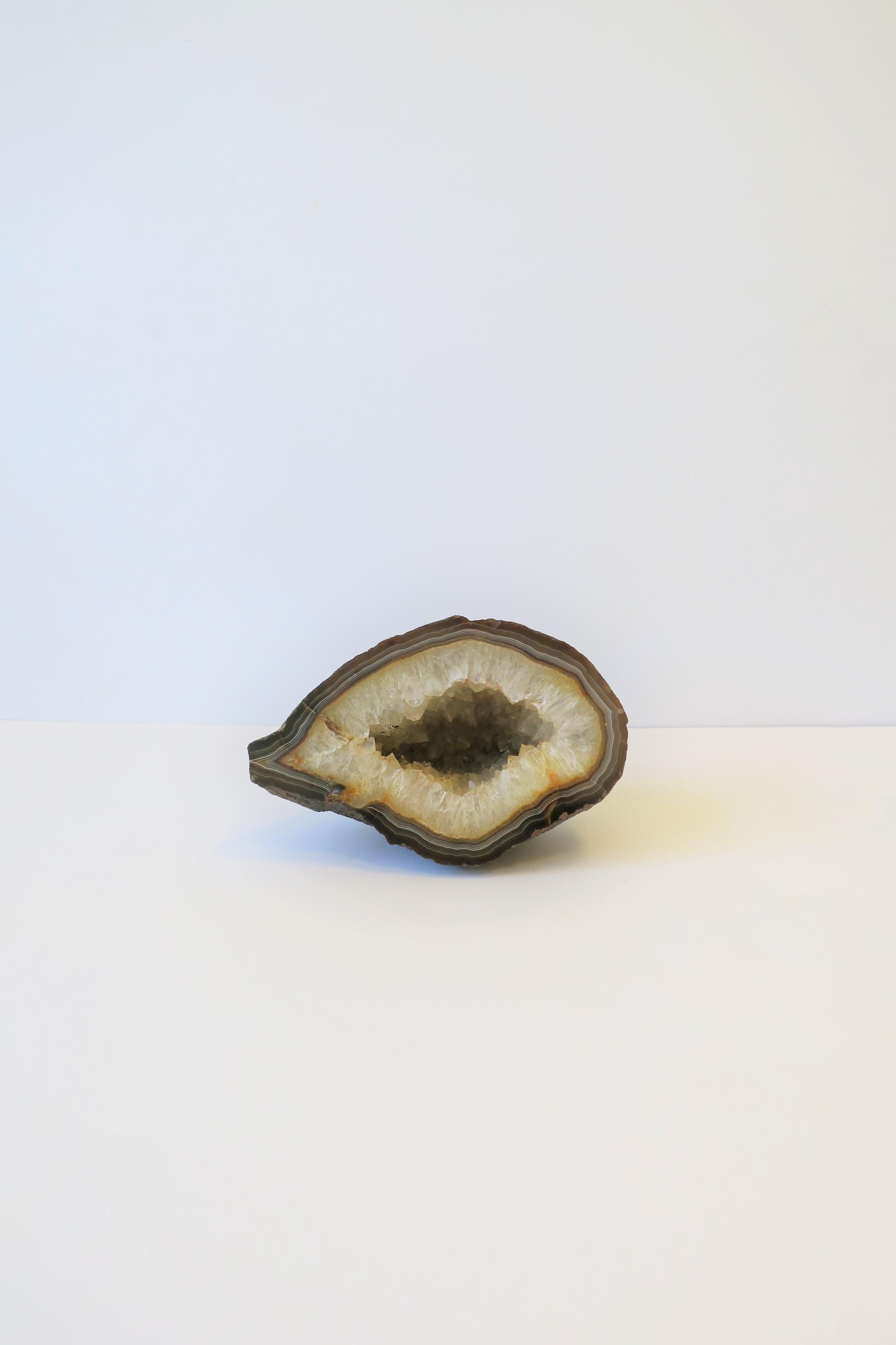 A beautiful and substantial white and brown agate geode natural specimen sculpture piece. Piece makes a great standalone decorative object, bookend, etc. 

Dimensions: 4.5