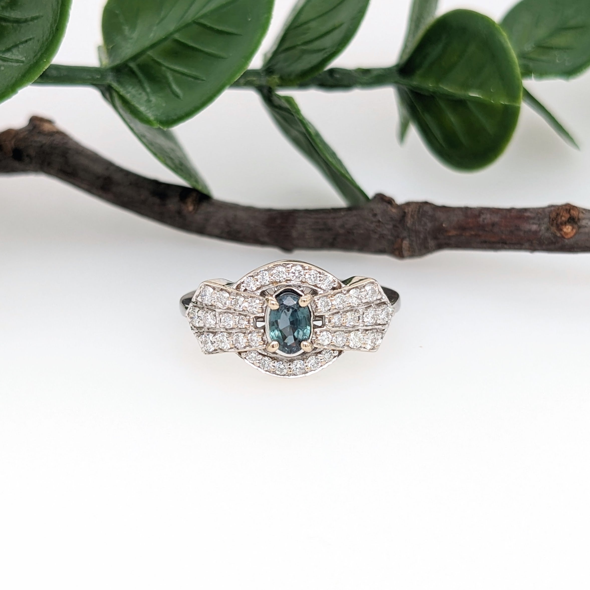 This unique ring features a natural color changing Alexandrite with natural earth-mined round diamond accents giving this ring a one-of-a-kind design. This beautiful piece was crafted in 14k solid gold featuring a 6x4mm oval alexandrite. This unique