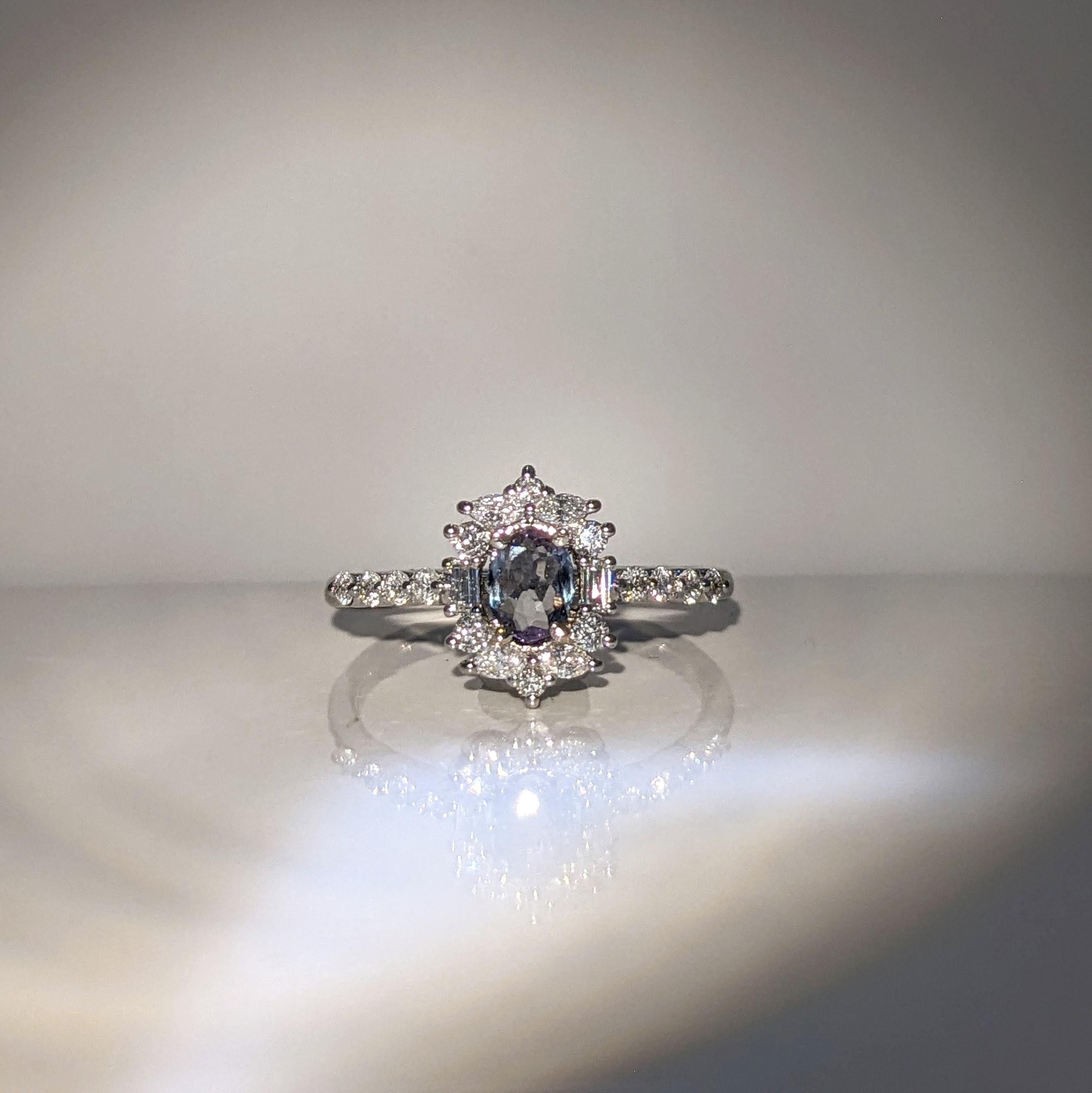 This beautiful ring features a 0.28 carat natural Alexandrite with natural earth mined diamonds set in solid 14K gold. This color changing alexandrite is a green/blue color in daylight with hints of purple that get more prominent in candlelight