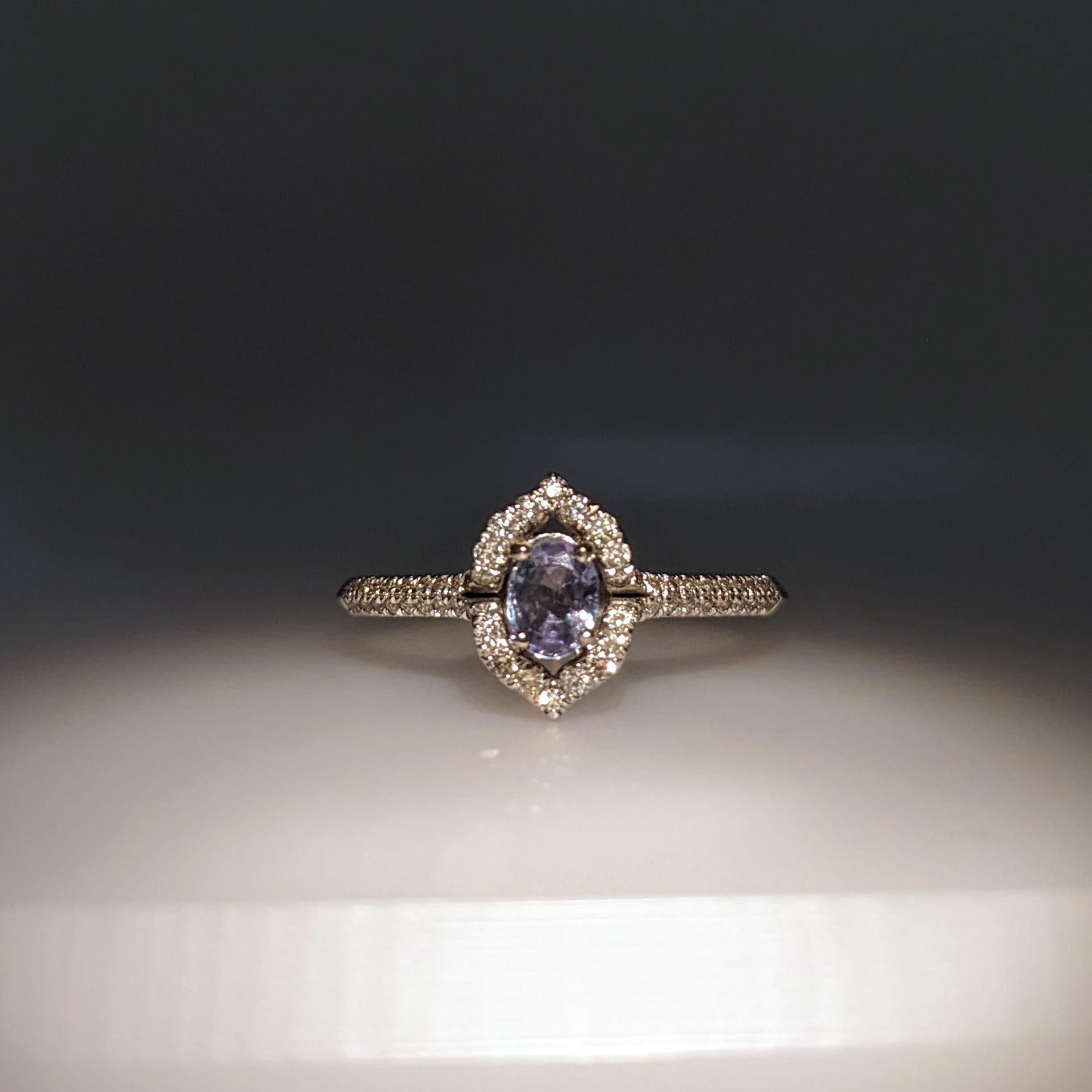 This beautiful ring features a 0.35 carat oval alexandrite gemstone with natural earth mined diamonds, all set in solid 14K gold. This color changing alexandrite is a green/blue color in daylight with hints of purple that get more prominent in