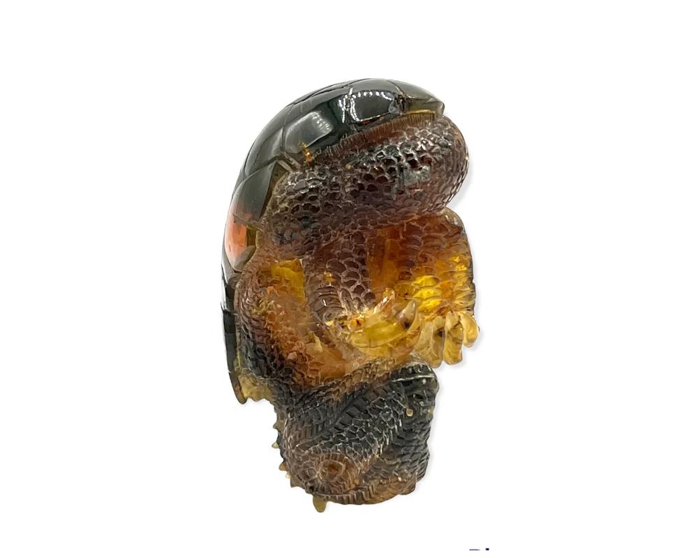 Natural Amber hand carved figurine of a Dragon Dinosaur Egg 
solid amber that was carved by hand in to this

In great Condition Ready to place on any desk or shelf.

Size is approximately 5 inches high by 2 inches deep

Due to the item's age