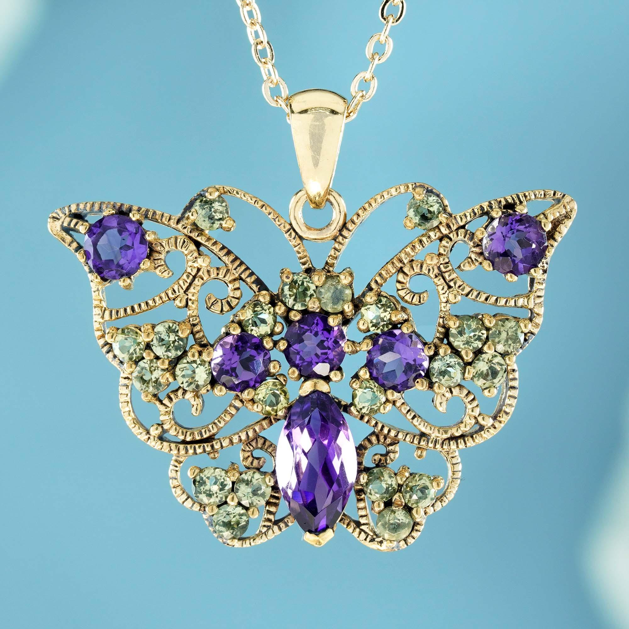 The elegant 24.06 carat vintage-style butterfly pendant crafted from natural amethysts and peridots, set in solid yellow gold. The butterfly has open milgrain wings with delicate veins, its body formed from  a larger marquise purple amethyst. Its
