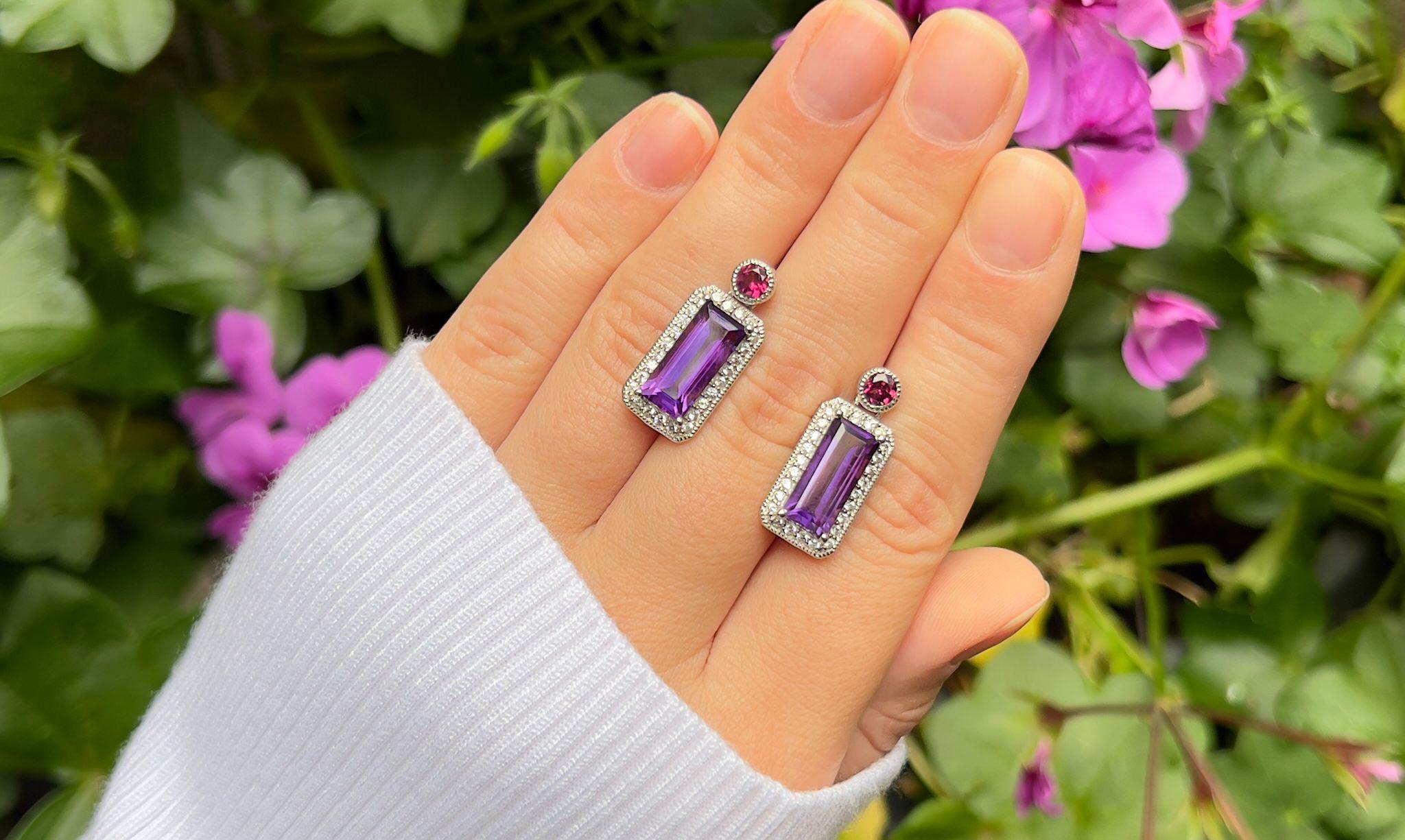 It comes with the appraisal by GIA GG/AJP  
Amethyst = 5.60 Carats ( 14 x 6 mm )
Cut: Baguette
Total Quantity of Amethyst: 2
Primary Stone Color: Purple
Rhodolite Garnet = 0.60 Carats
White Topaz: 0.80 Carats
Metal: Sterling Silver
Back Finding: