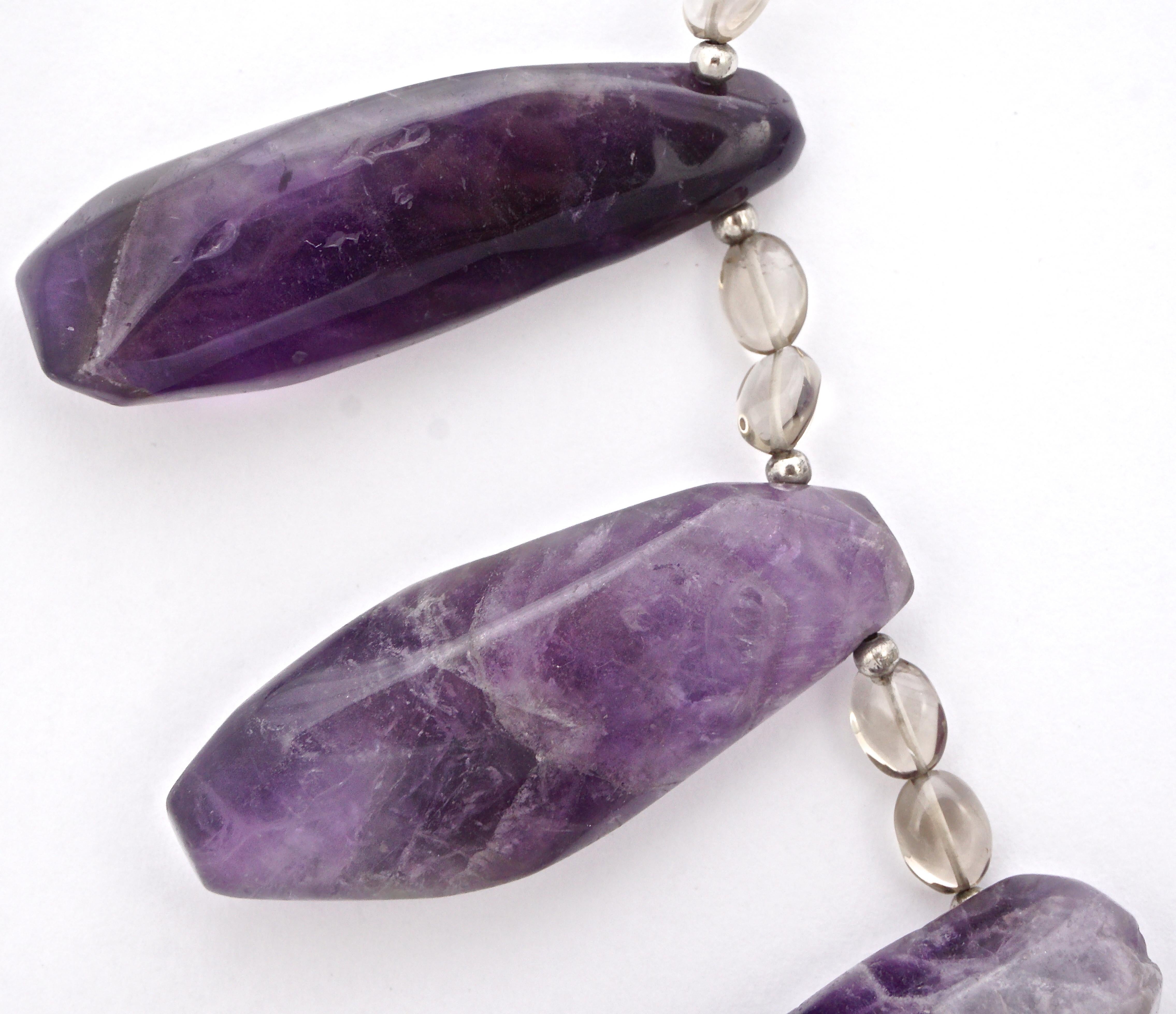 Lovely clear glass necklace interspersed with silver tone balls, featuring seven chunky pieces of natural amethyst. The hook clasp is not stamped but tests as silver. The necklace measures length 40.7cm / 16.02 inches, and the middle amethyst is