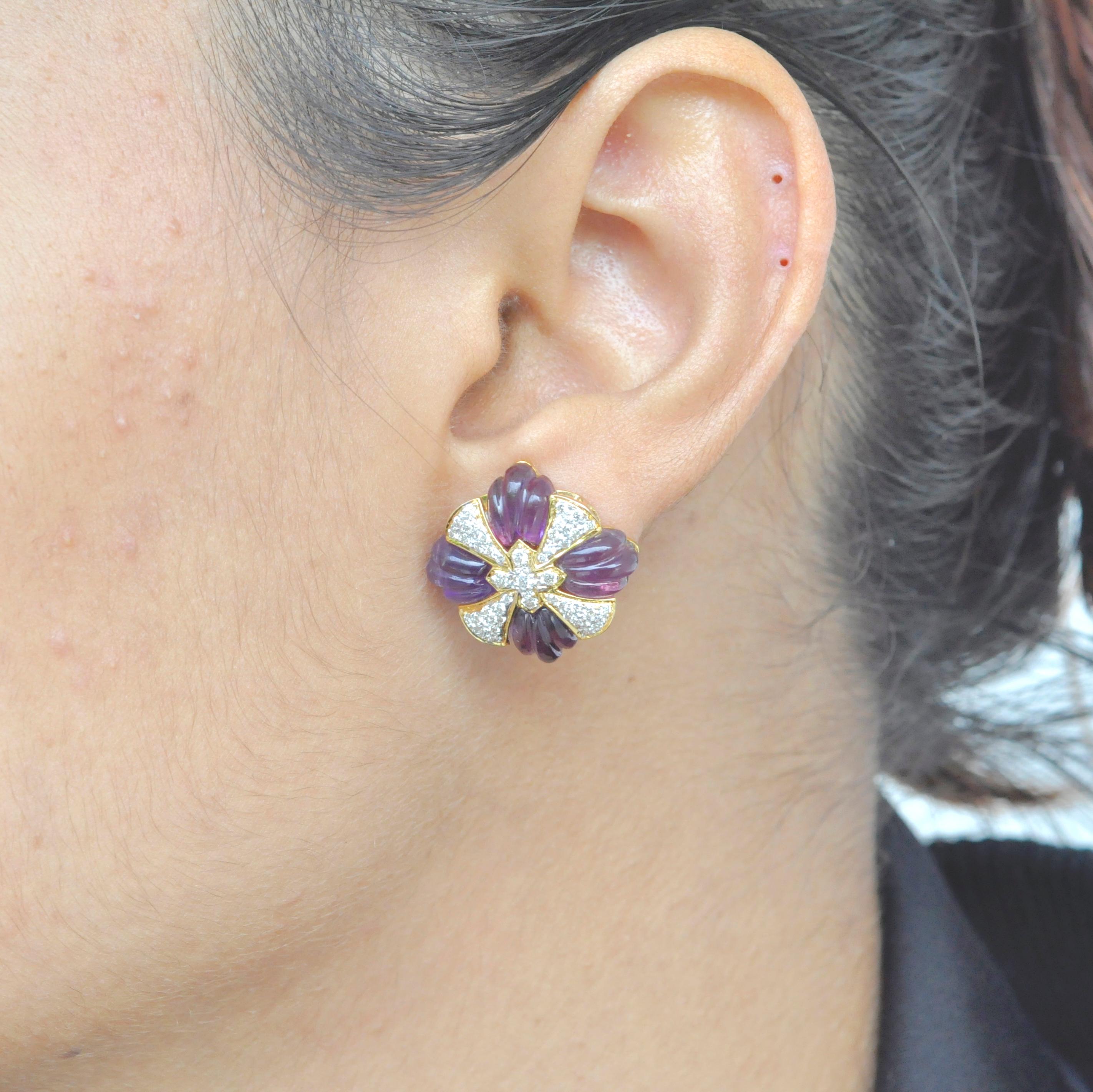 A beautiful classic yet unique amethyst carving stud earrings is a chic piece to have in your jewelry closet. The earrings uses 18 Karat yellow gold with diamonds and amethyst carving precisely set in the shape of a wheel complimented by pave set