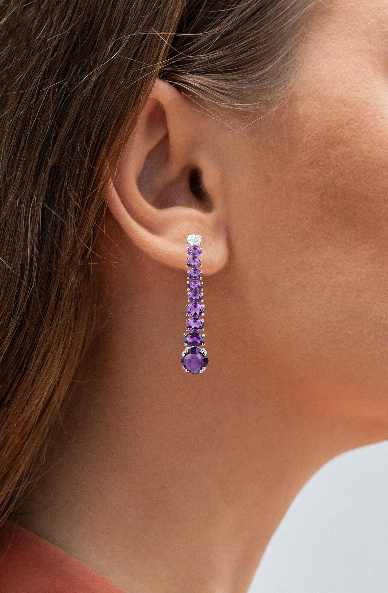 It comes with the appraisal by GIA GG/AJP
All Gemstones are Natural 
18 Amethysts = 7.14 Carats
2 White Topaz = 0.44 Carats
Metal: Sterling Silver
Post With Friction Back
Length: 40 mm