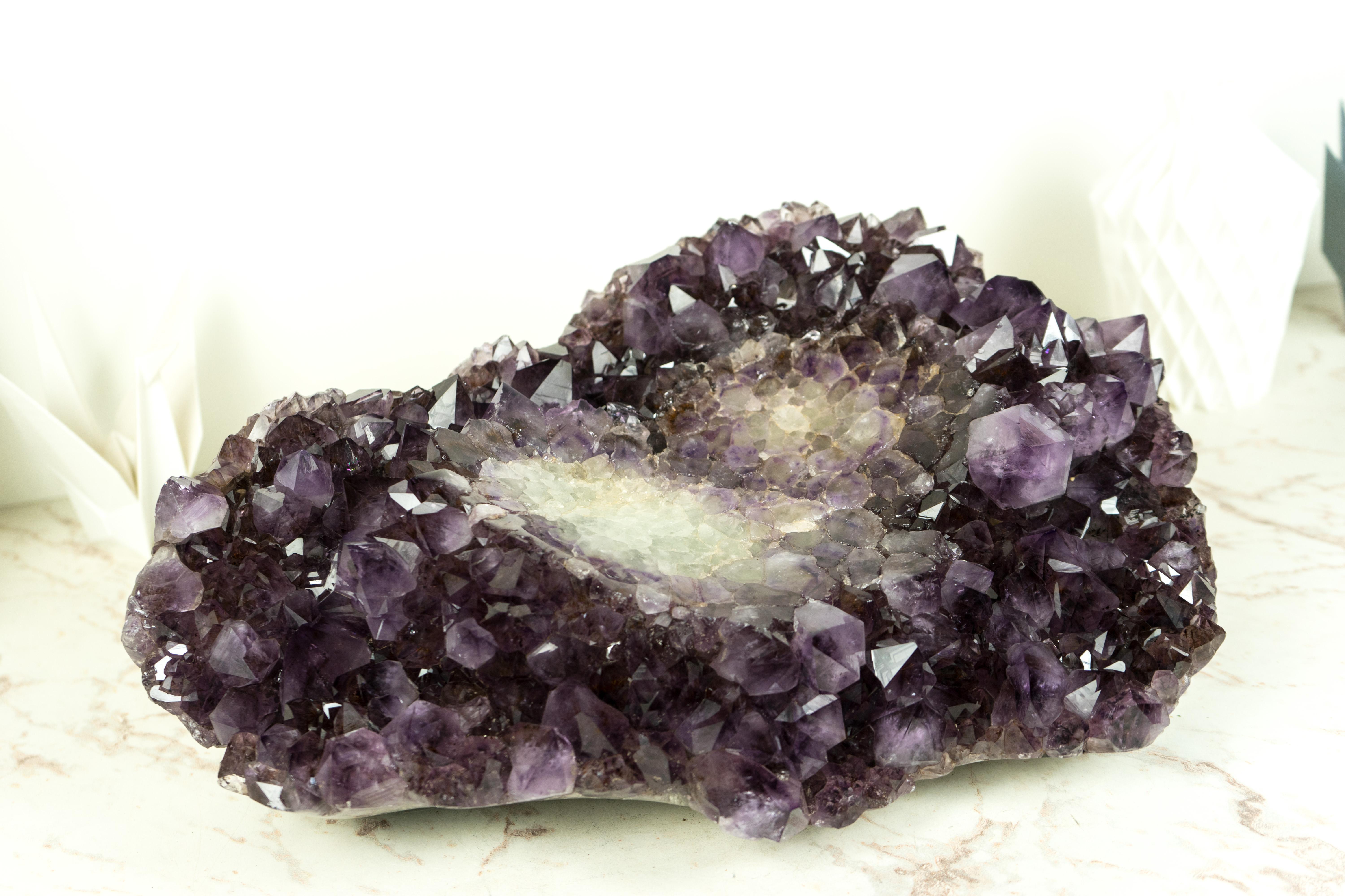 Hand-carved from a unique X-Large Amethyst Cluster that was meant to become a decorative bowl, this Amethyst will beautifully enhance your home or workspace decor. Whether used as a place to display crystals, a decorative piece, an exquisite crystal
