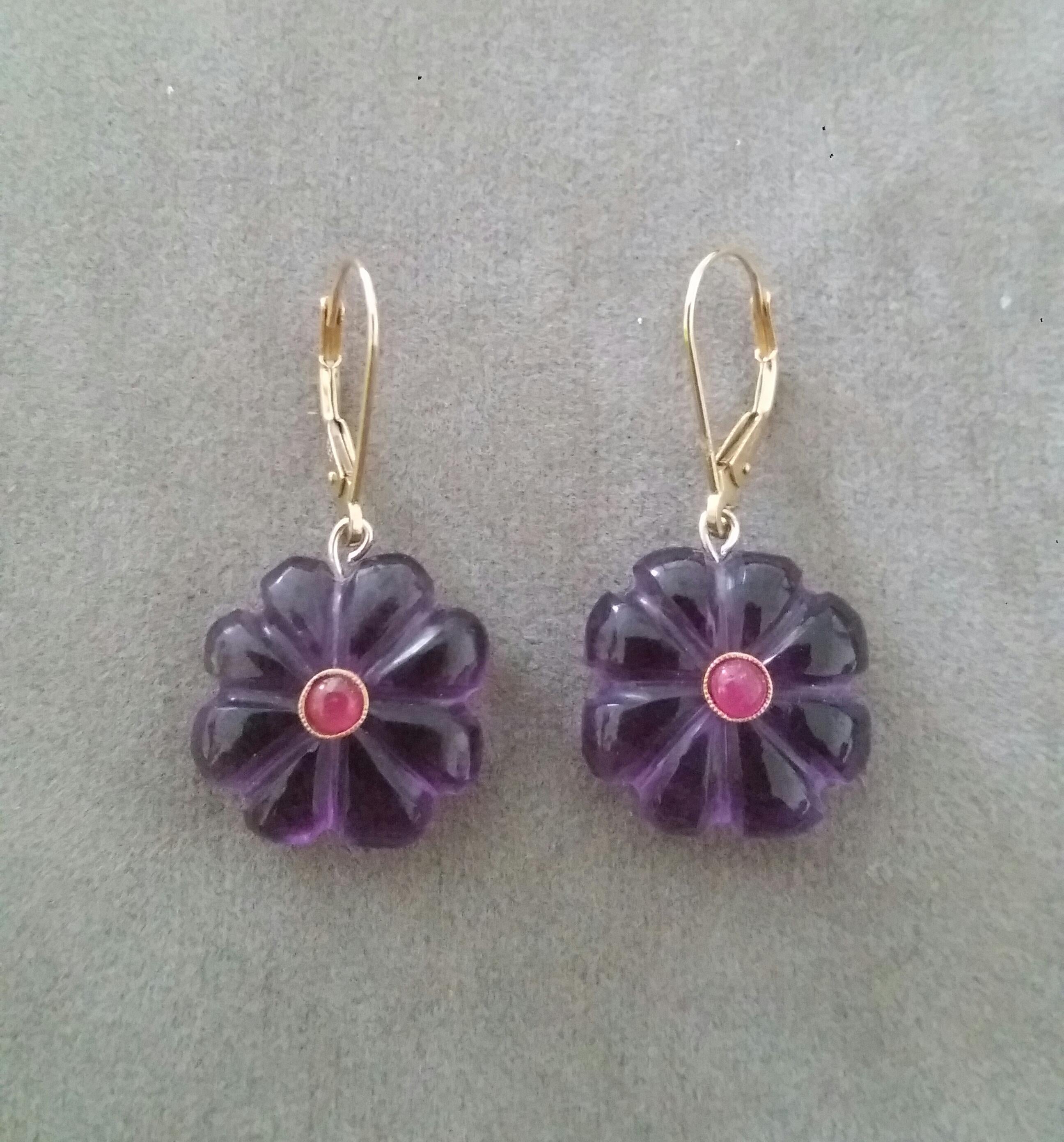 Simple chic earrings composed of 2 Natural Amethyst Carved Buttons of 16 mm in diameter with a small Ruby cabochon in the center suspended by a 14 K yellow gold clip.

In 1978 our workshop started in Italy to make simple-chic Art Deco style