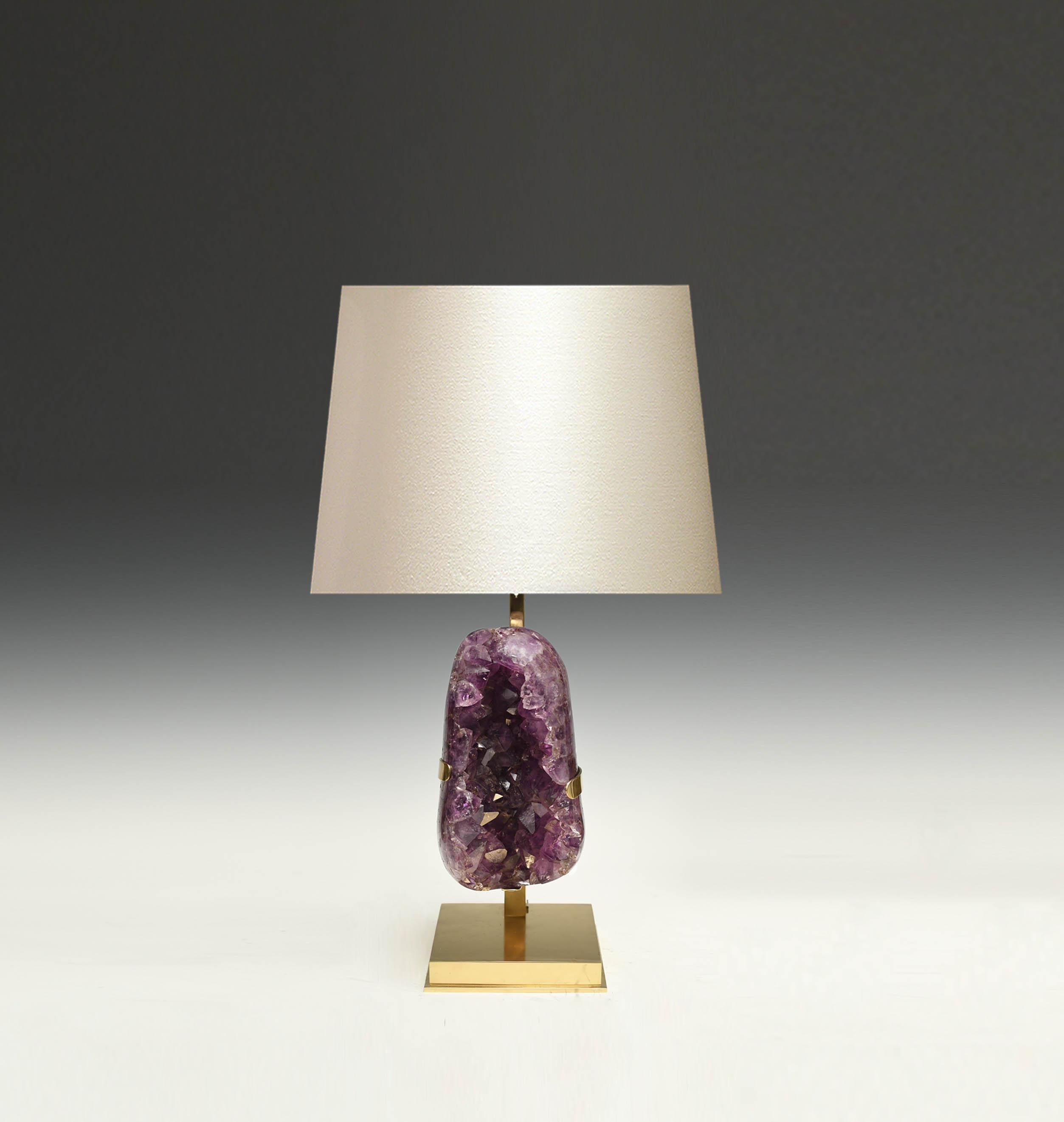 A natural amethyst sculpture mounts as a lamp. Polish brass stands. Create by Phoenix gallery NYC.
To the top of amethyst is 14in.
Each lamp installs two sockets.
Lampshade do not include.
 