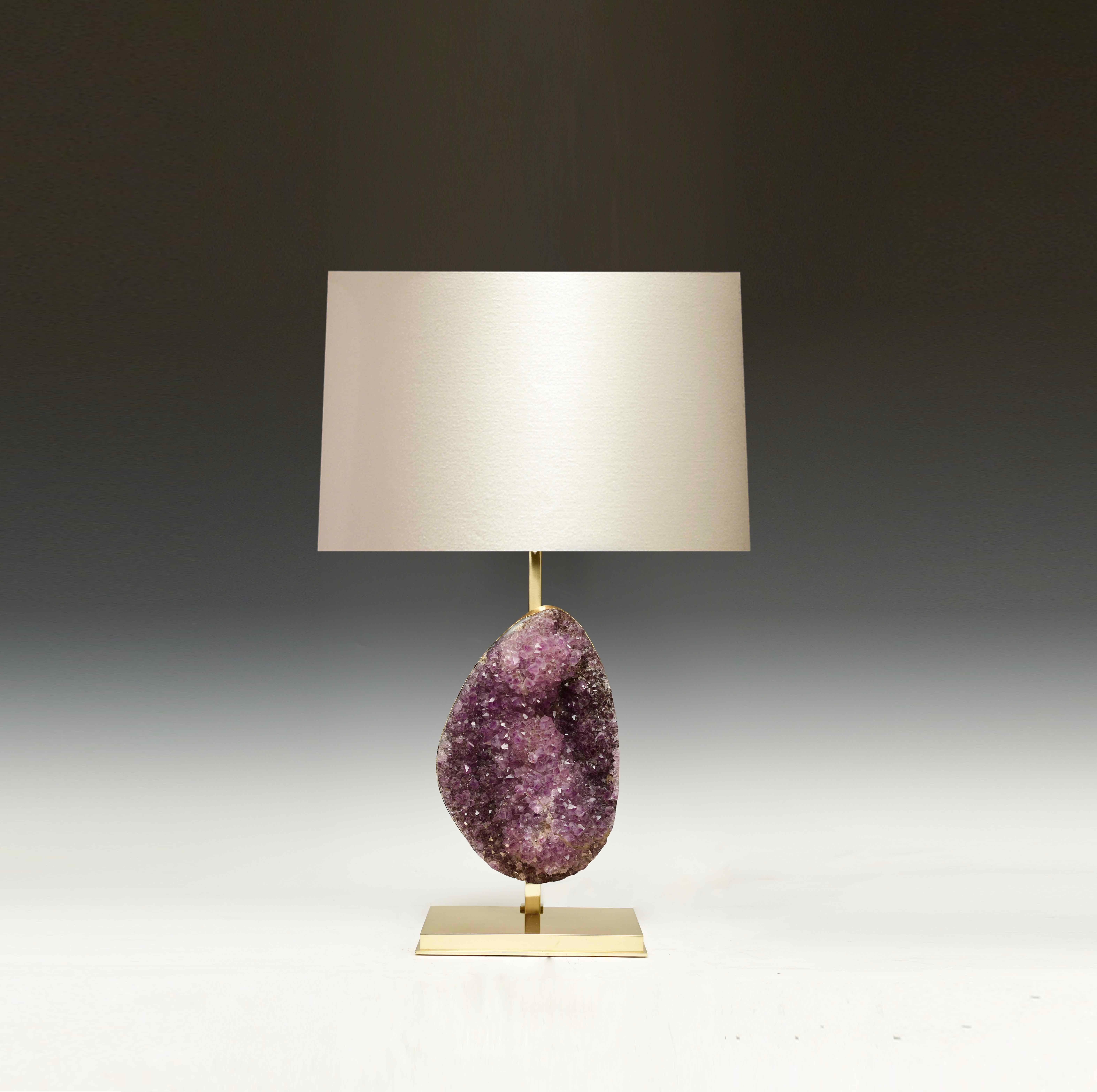 A natural amethyst sculpture mounts as a lamp. Polish brass stands.
Each lamp installs two sockets.
Lampshade do not include.
 