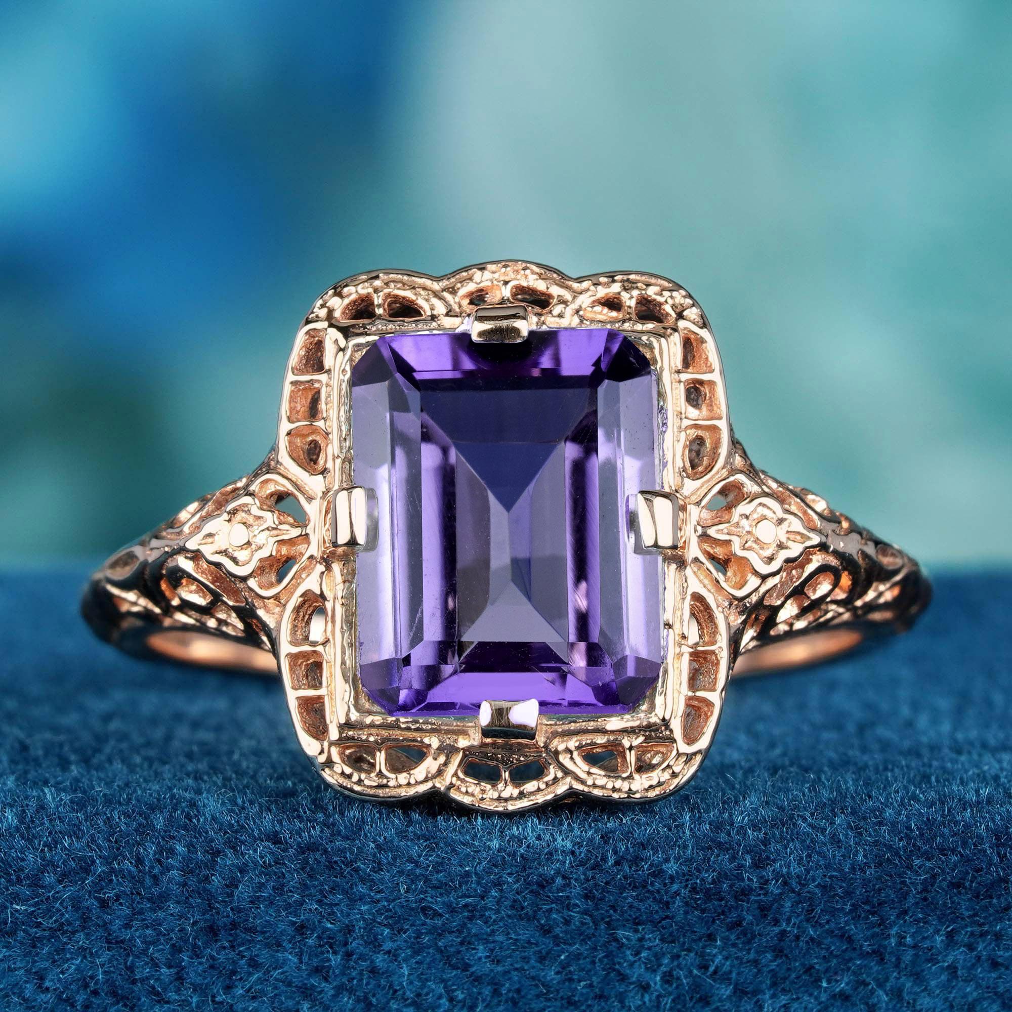 Indulge in the exquisite beauty of the Natural Amethyst Vintage Style Filigree Ring in 9K Rose Gold. At its heart lies a stunning natural emerald cut amethyst, elegantly set in a delicate filigree design. Crafted from quality 9K rose gold, the