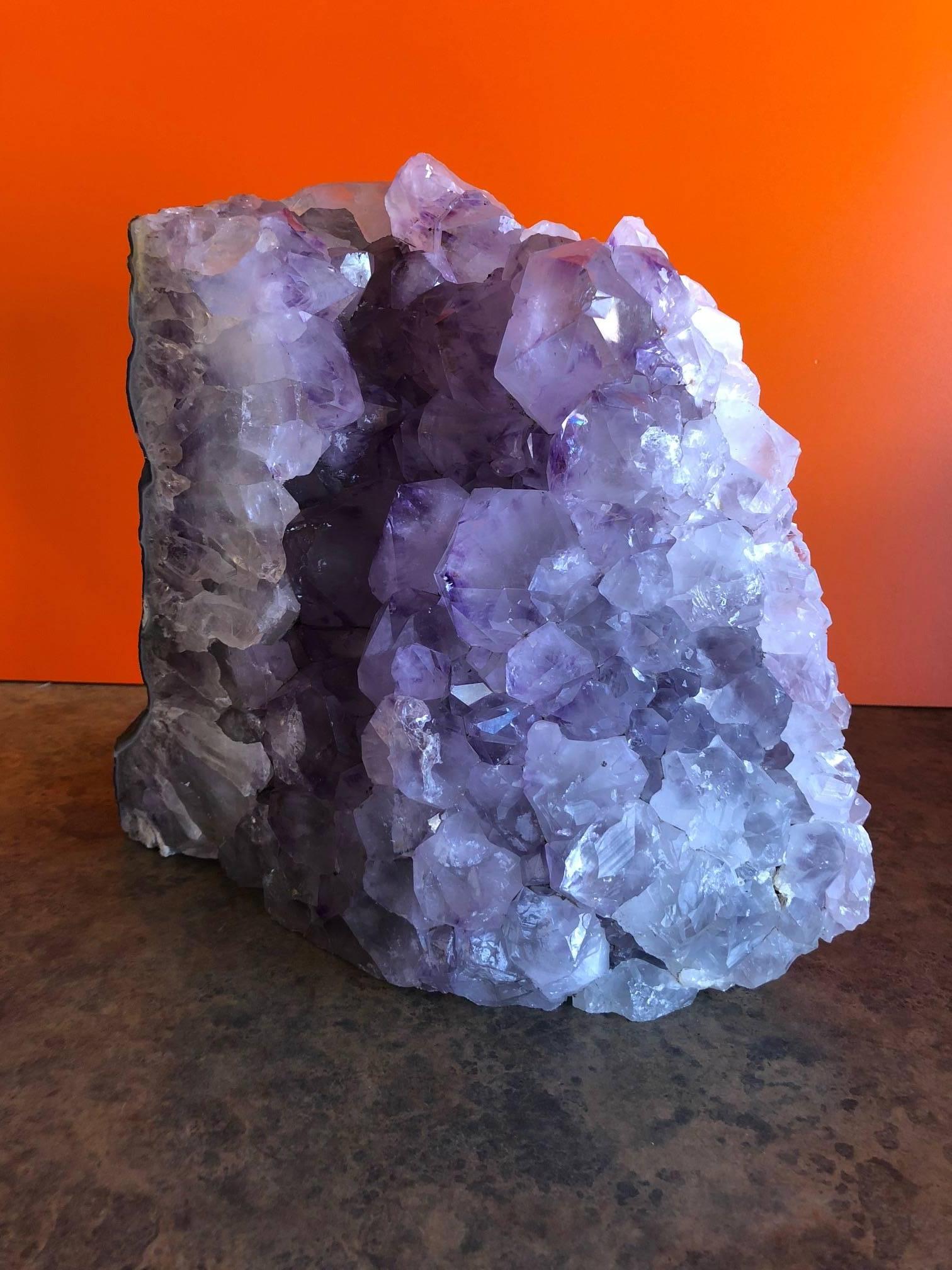 Weighing in at almost 20 pounds, this stunning natural amethyst crystal cluster / agate geode is believed to be from Brazil and would make a great decorative piece or addition to any mineral collection!

The piece is all natural and displays very