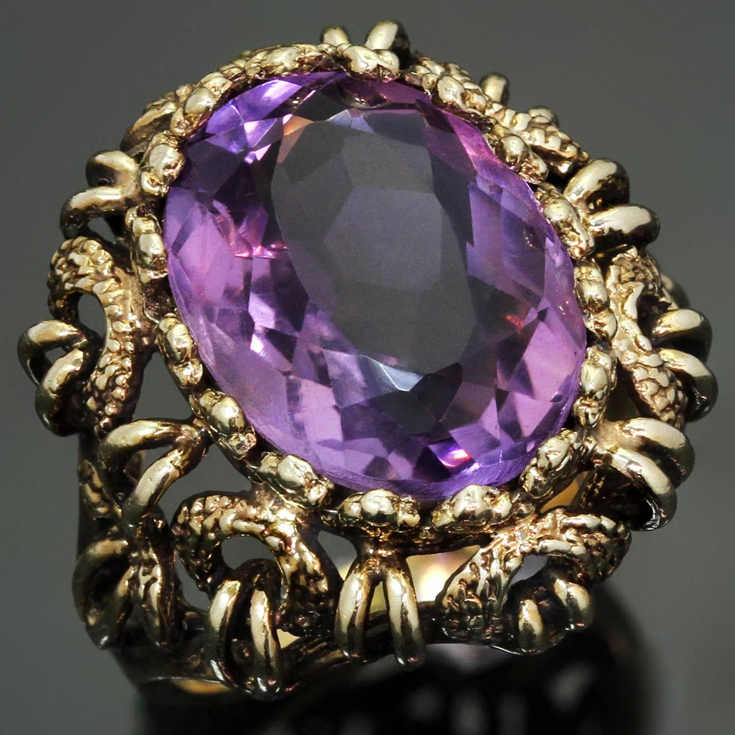 This fabulous vintage cocktail ring is beautifully hand-crafted in 14k multi-textured yellow gold and is beautifully set with a faceted oval natural amethyst stone. Made in United States circa 1970s. Measurements: 0.70